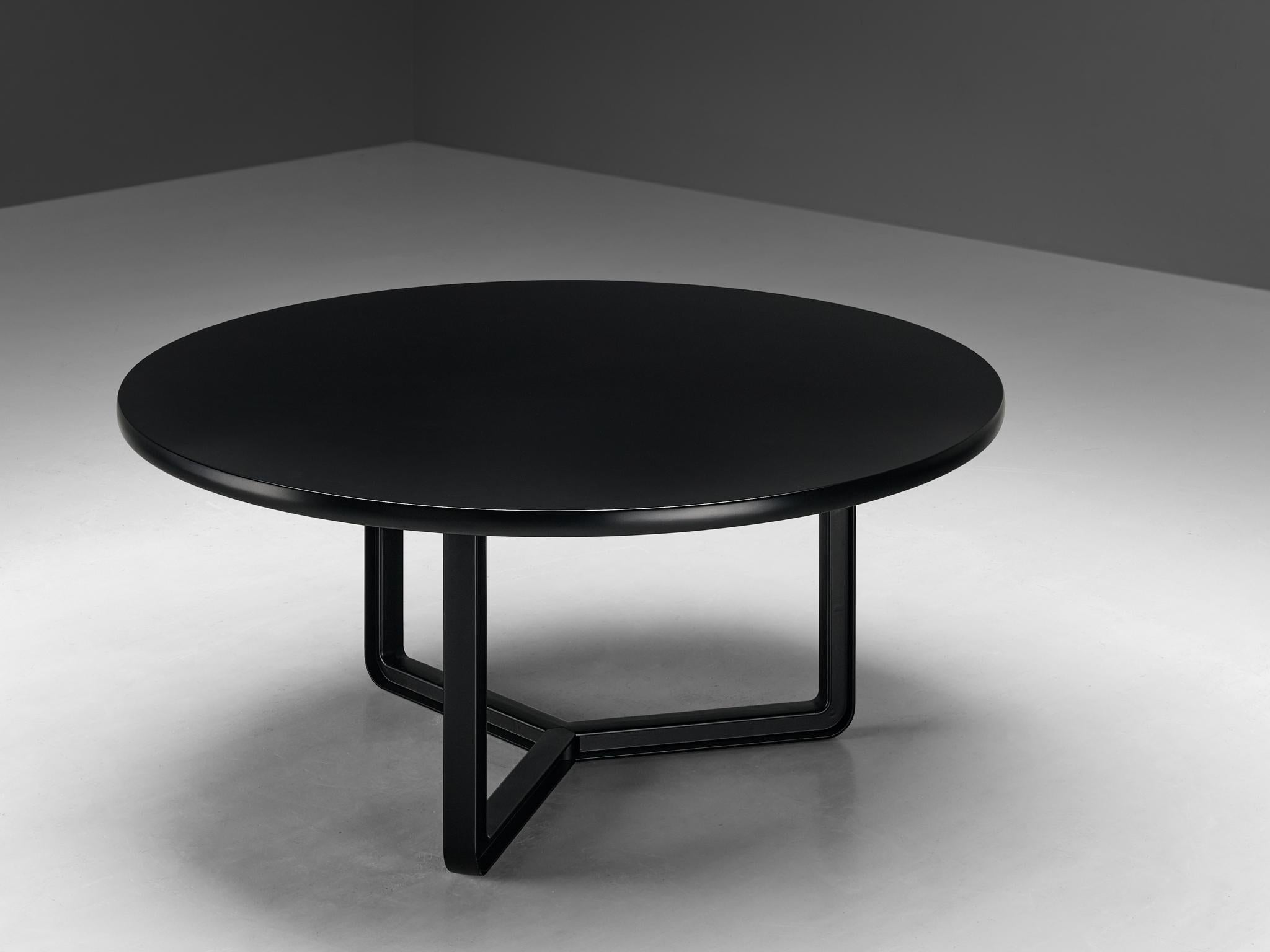 Centro Progetti Tecno, dining table model 'T334C', lacquered wood, lacquered aluminum, Italy, 1975-1978

Round dining table with a black lacquered wooden top that has an incredibly soft texture. The tabletop is mounted on a three-legged metal frame
