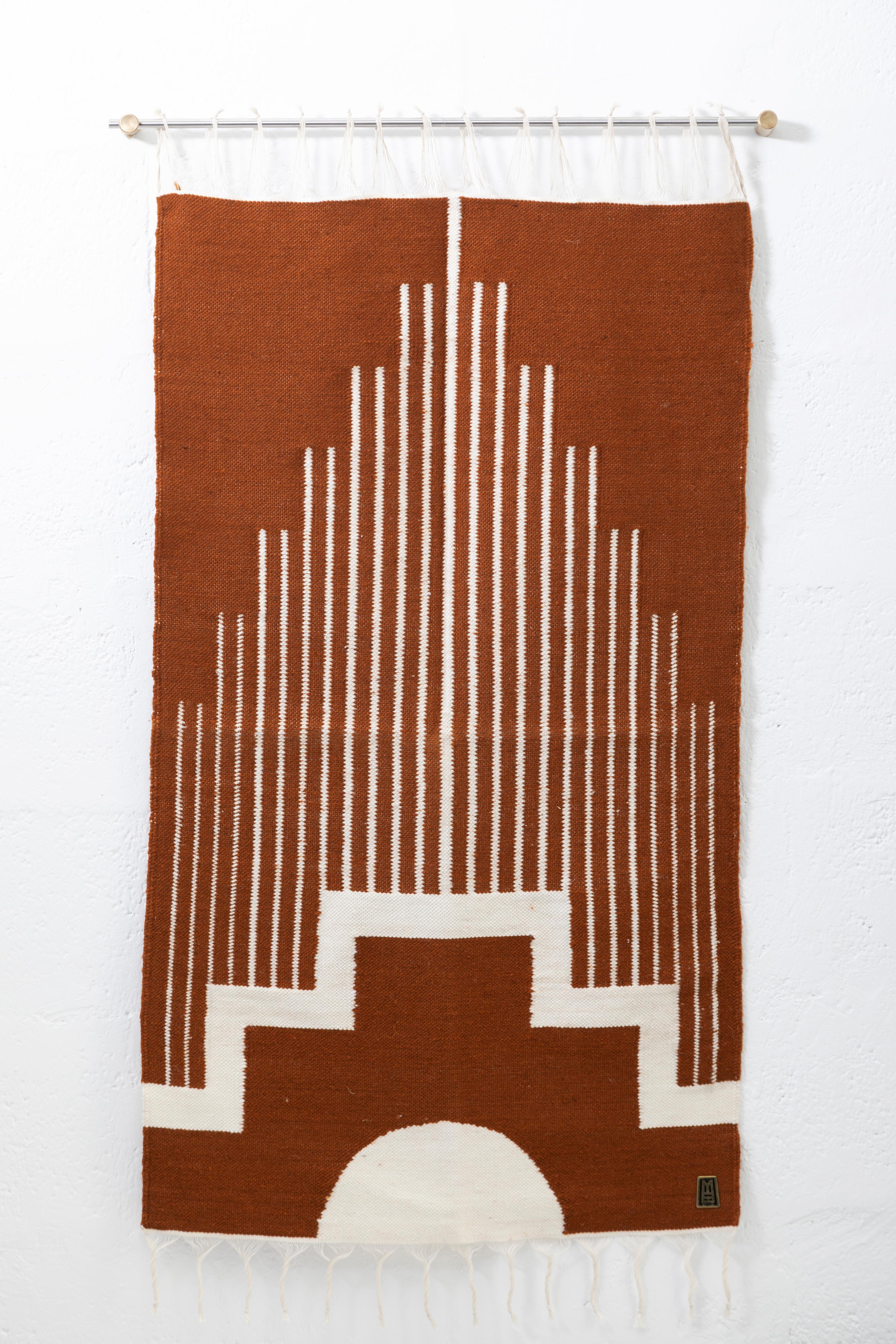 Handwoven sheep wool tapestry with wall-mounting lathed aged bronze bases, and stainless steel rod.

Capturing the essence of the Andes, these pieces are created using ancient weaving techniques yet loomed through an innovative approach to