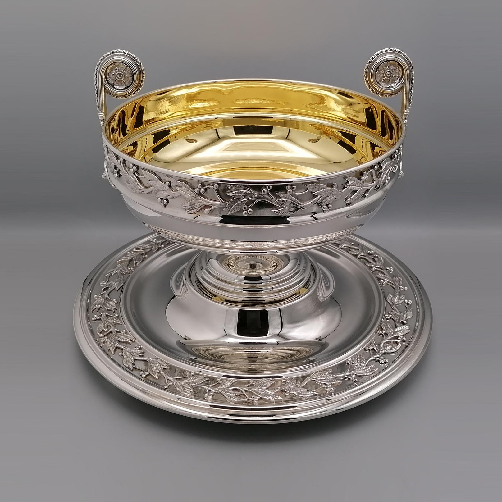 Centerpiece with plate made of 800 solid silver in Renaissance style. 
The centerpiece was made love with different processing methods. 
The predominant method is handcrafting, which makes it precious and unique. 
Leaves and olives are being made by