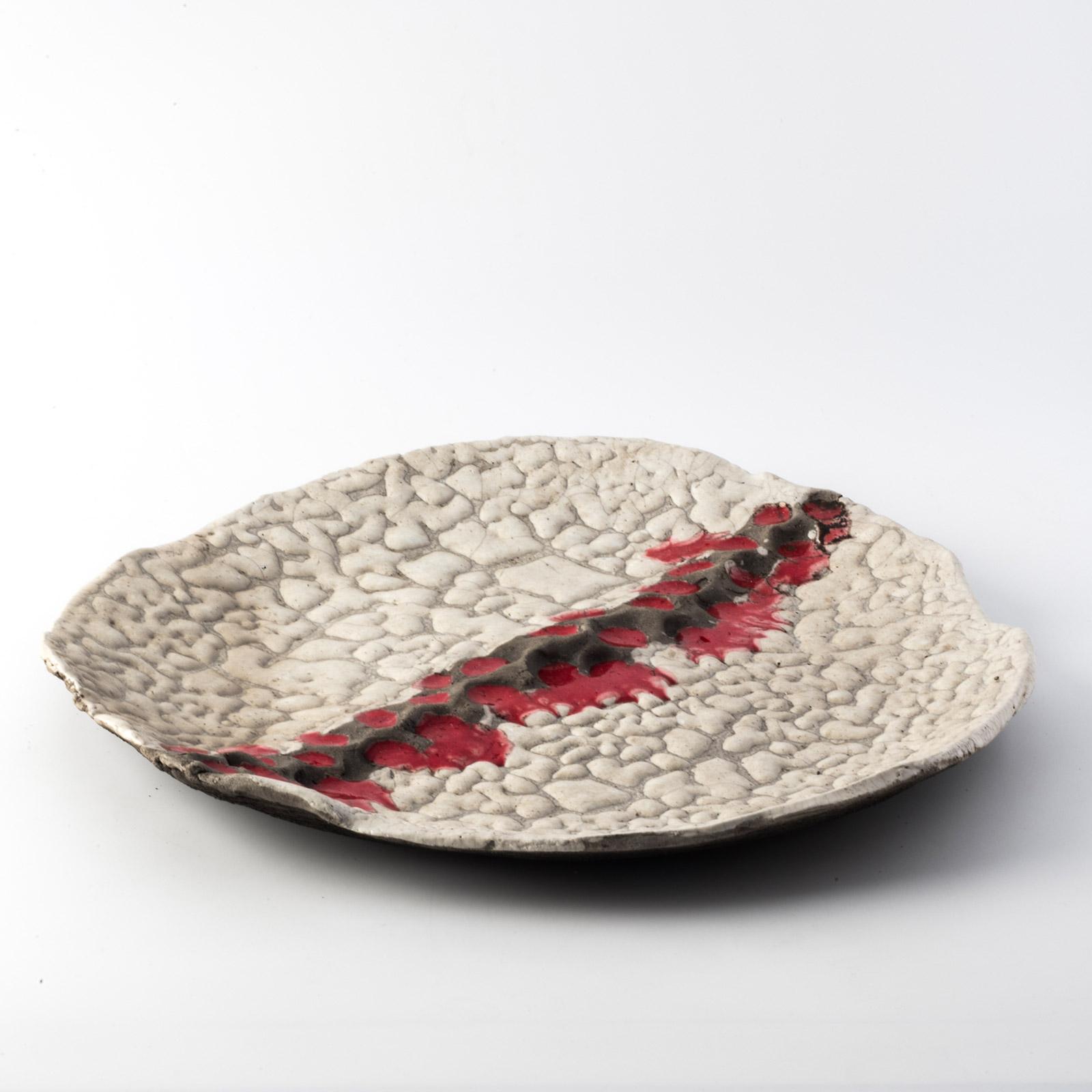 A very personal interpretation of making pottery transforms the texture of the LARGE MOON IN RED dish into a striking relief decoration with voids and solids  never the same that add the value of uniqueness. 
Designed and modeled entirely by hand by