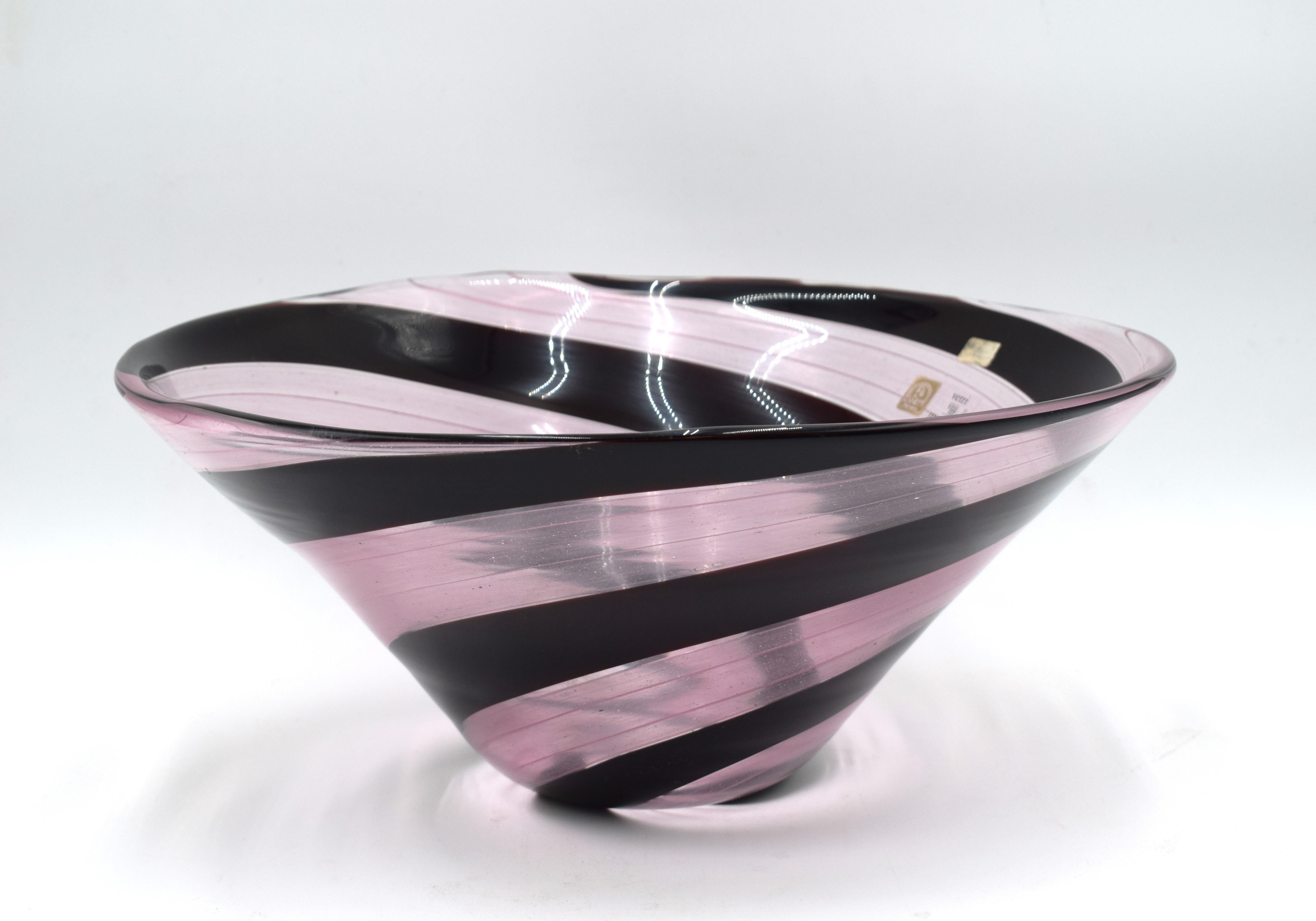 Gran centro de mesa de cristal de Murano rosa y negro, fabricado por Zanetti, hacia los años 70.
Firma y etiquetas de producción presentes.
Excelente estado general, sin fallos ni defectos, ver fotos.
Dimensiones: A= 17 cm; P= 39 cm.