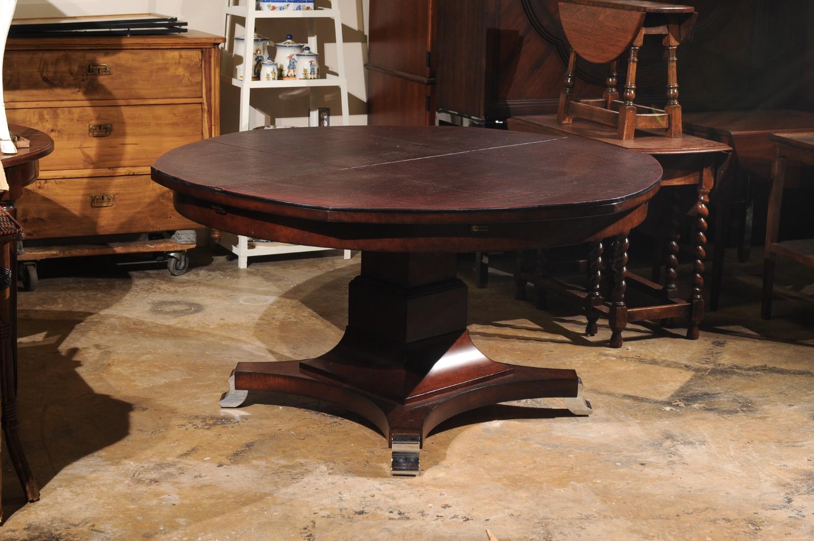 Beautiful Century Furniture Company Dining Table.

This Transitional Dining table enlarges with leaves included in its own Cabinet, making for easy storage. Custom Table pads are also included.

The base has Chrome footed accents. 

Table Retail for