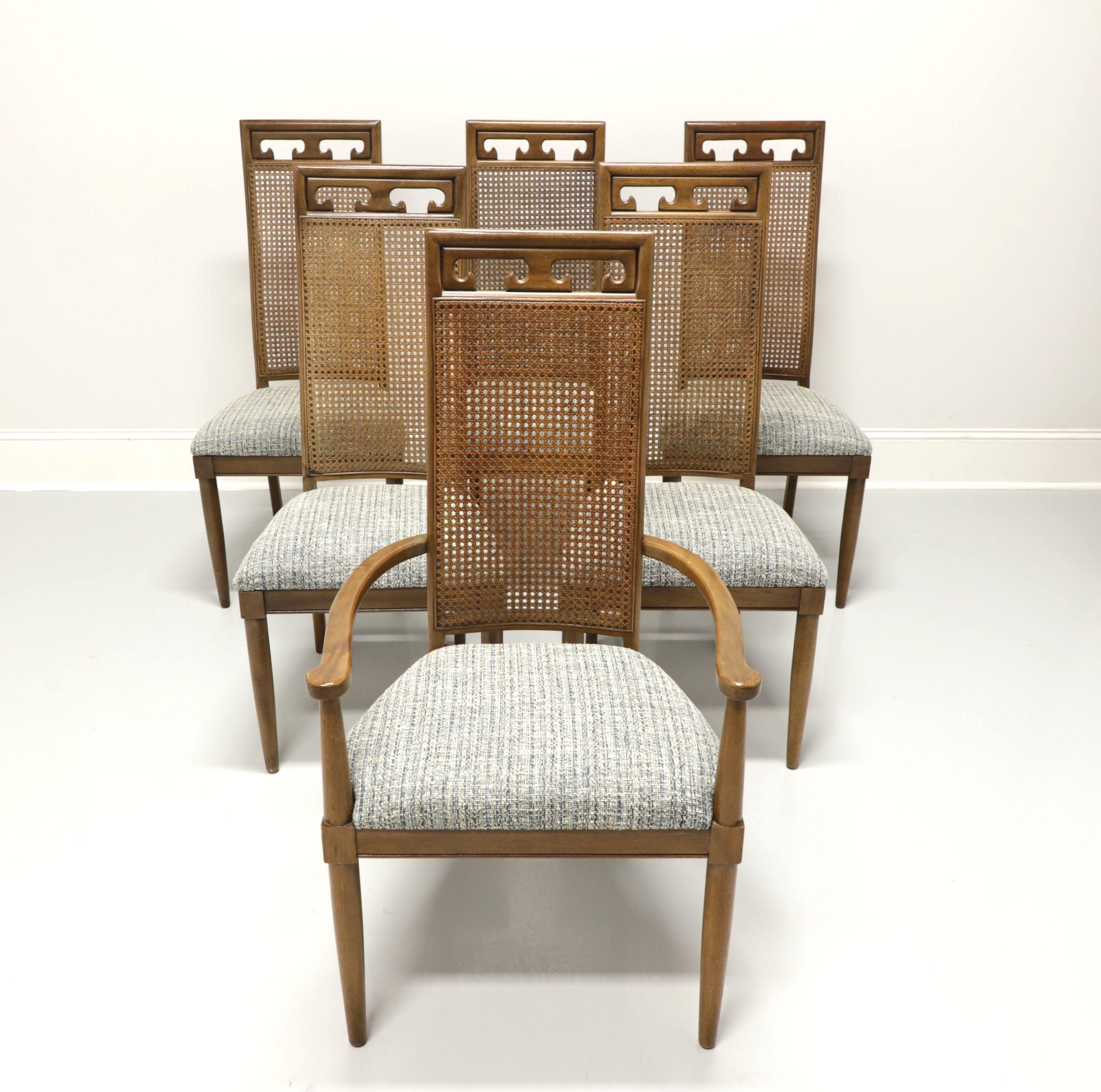 A set of six Spanish style dining chairs by Century Furniture. Solid walnut, carved crestrail, high cane backs, blue & grey color fabric upholstered seats, round tapered front legs and square back legs. Set includes 1 armchair and 5 side. Made in