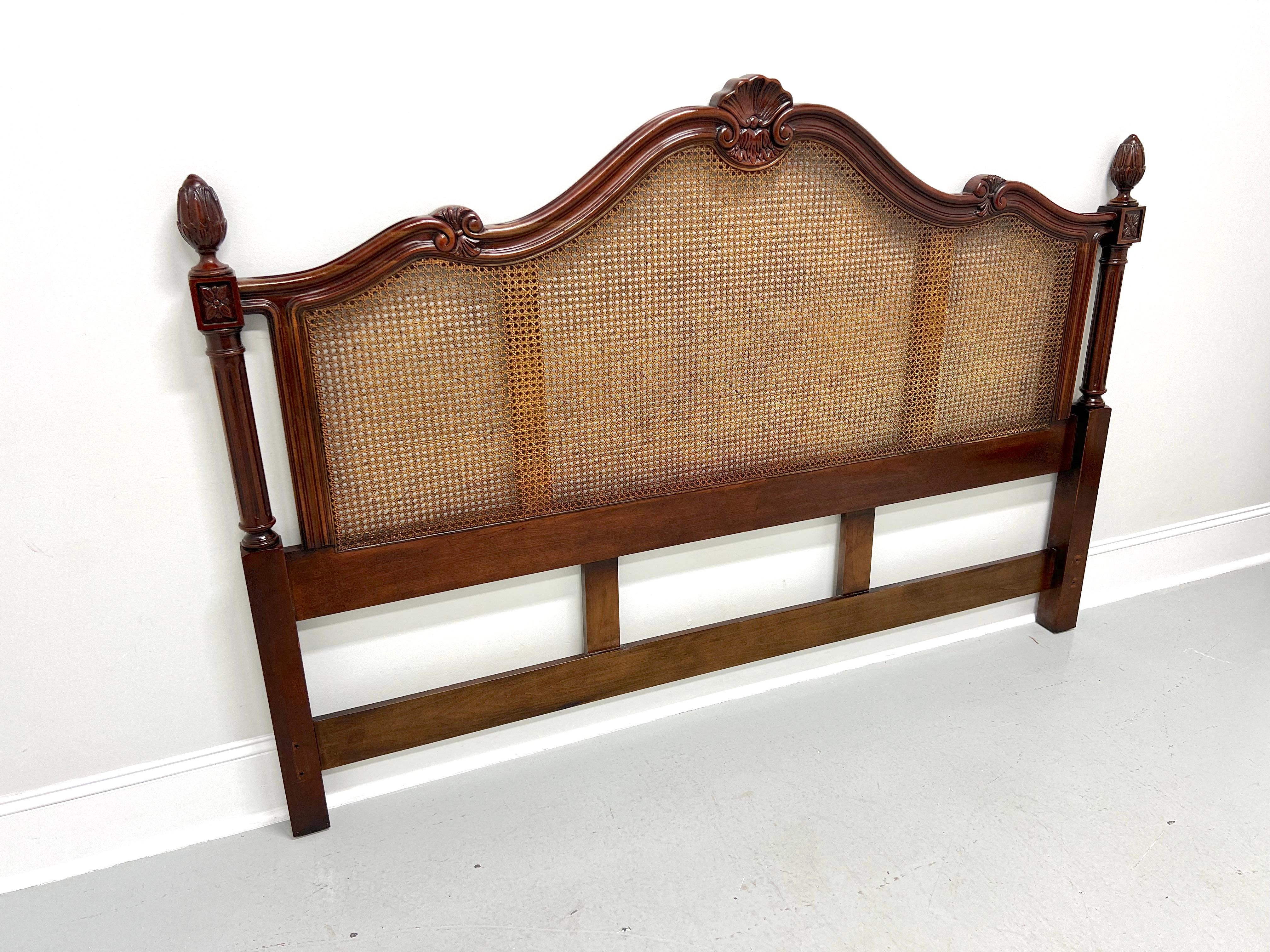 An Italian Provincial style king size headboard by Century Furniture, from their Cardella Collection. Cherry wood frame, decoratively carved, arched top with center carved shell, center inset with caning, low posts at sides with fluted columns and