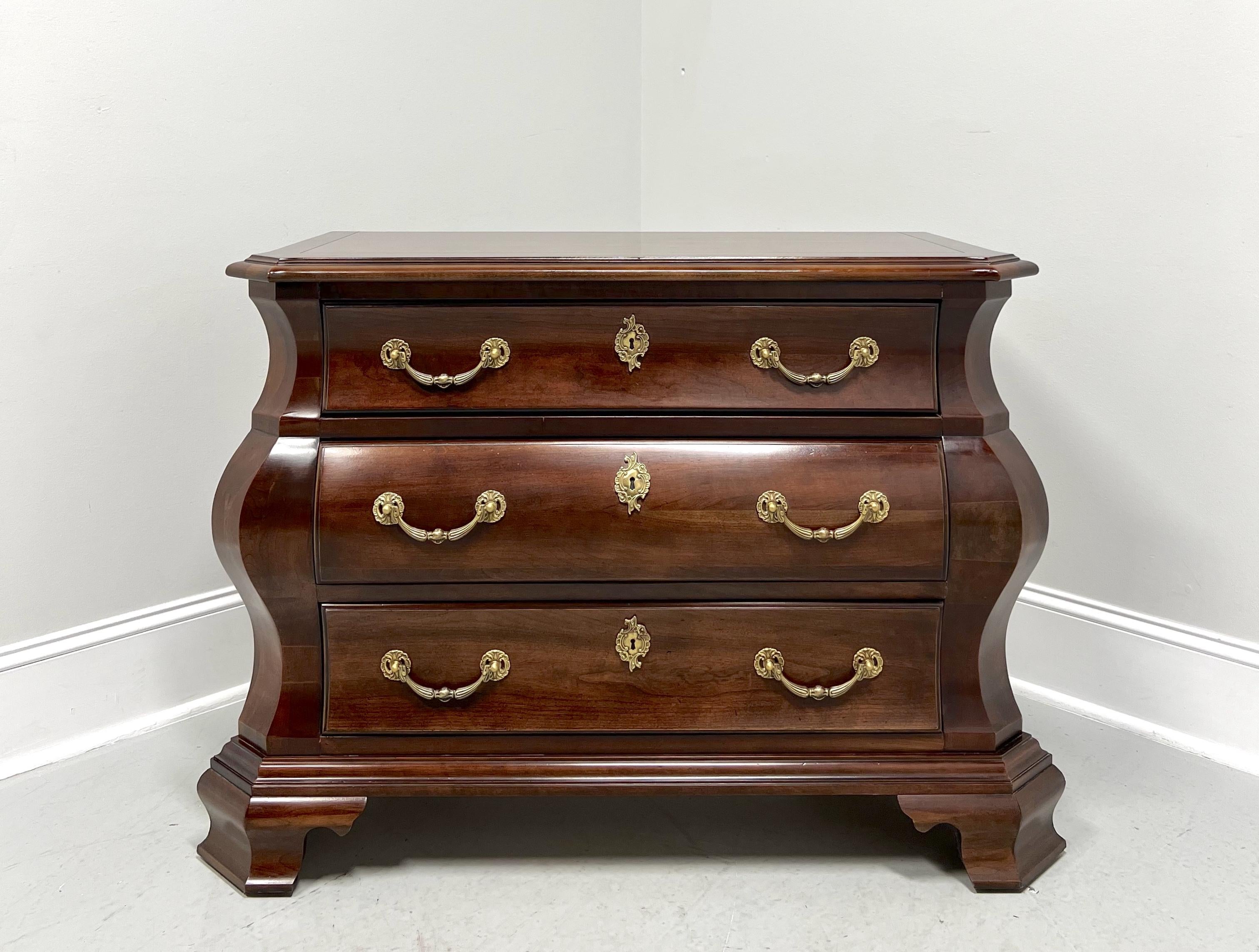 An Italian Provincial style bachelor chest by Century Furniture, from their Cardella Collection. Cherry wood with decorative brass hardware, bombe shaped, banded top with bevel edge & clipped corners, and ogee bracket feet. Features three drawers of
