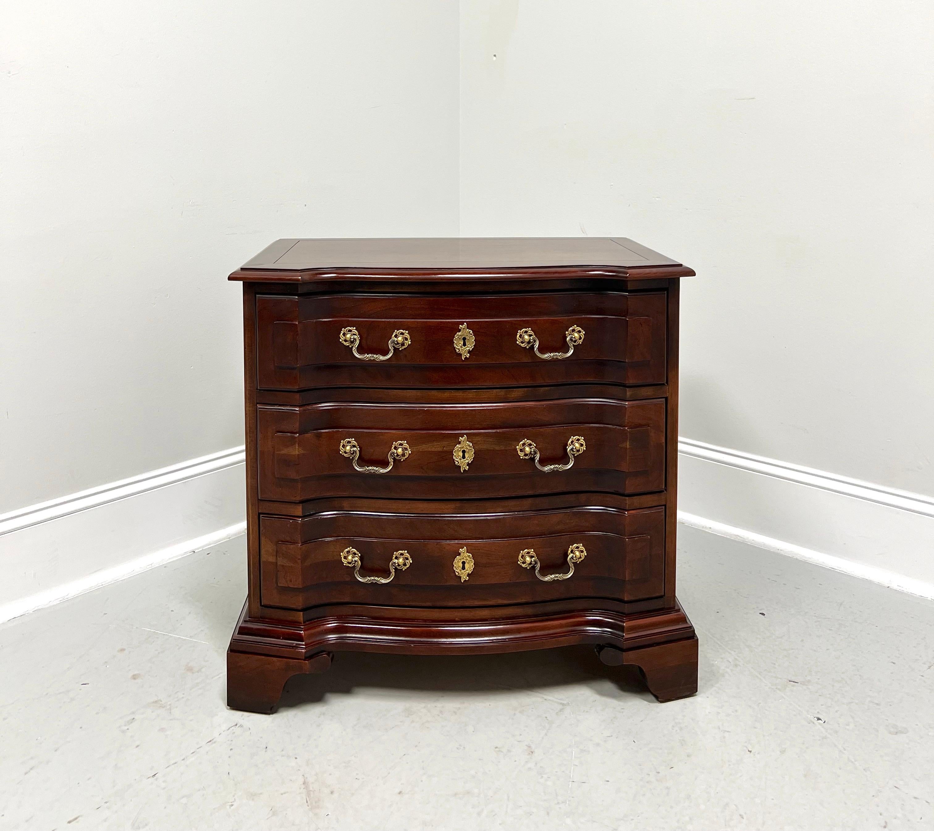 An Italian Provincial style nightstand by Century Furniture, from their Cardella Collection. Cherry wood with decorative brass hardware, block front, banded top with an ogee edge & squared corners, finished on all sides, and bracket feet. Features