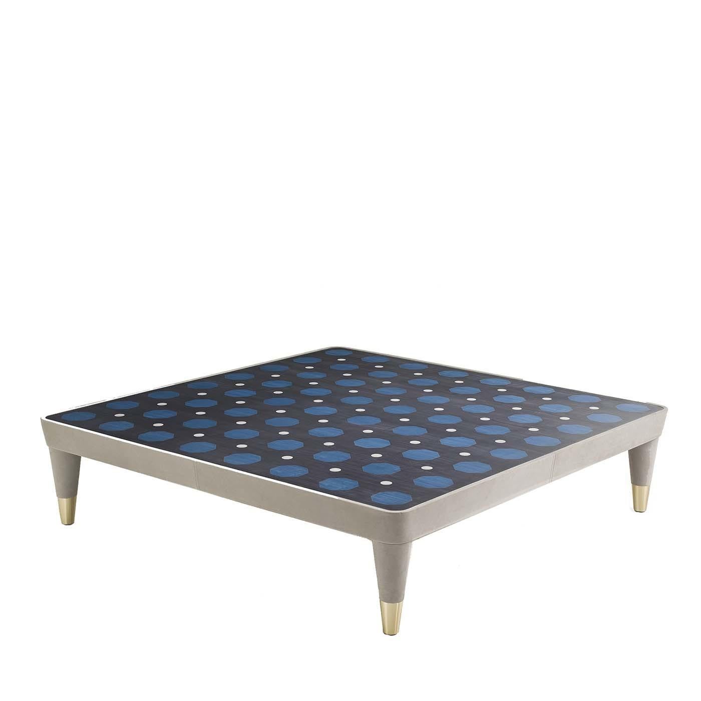 Part of the Century collection, this coffee table boasts midcentury proportions and patterned decorations that will make a statement in a modern decor. This piece has a strong visual impact, thanks to its stunning finishes. Nubuck leather covers its