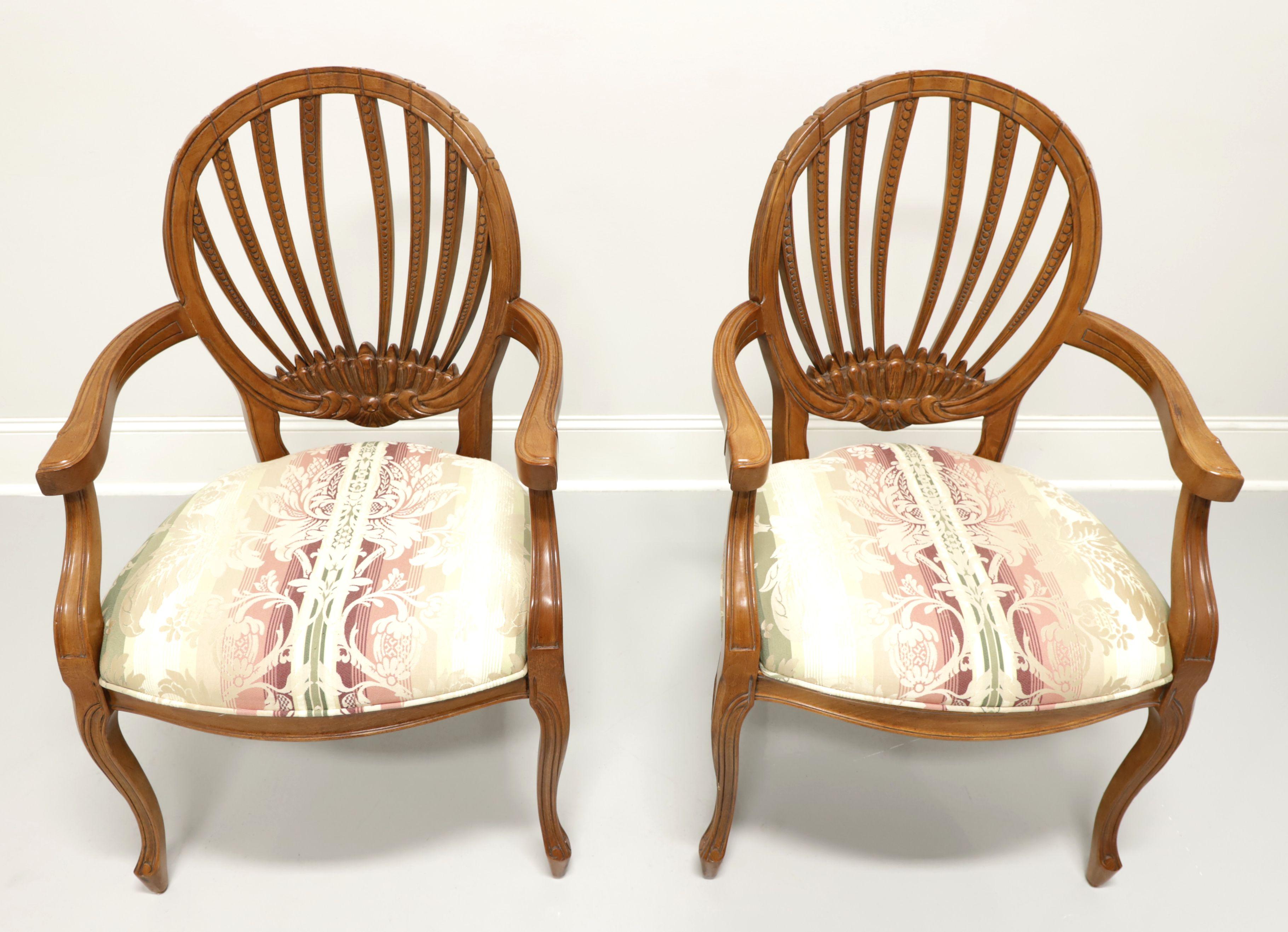 A pair of French Country style dining armchairs by Century Furniture, of Hickory, North Carolina, USA. Hardwood with a walnut finish, oval open carved design backs, carved curved arms, floral striped pattern fabric upholstered seats and curved legs.