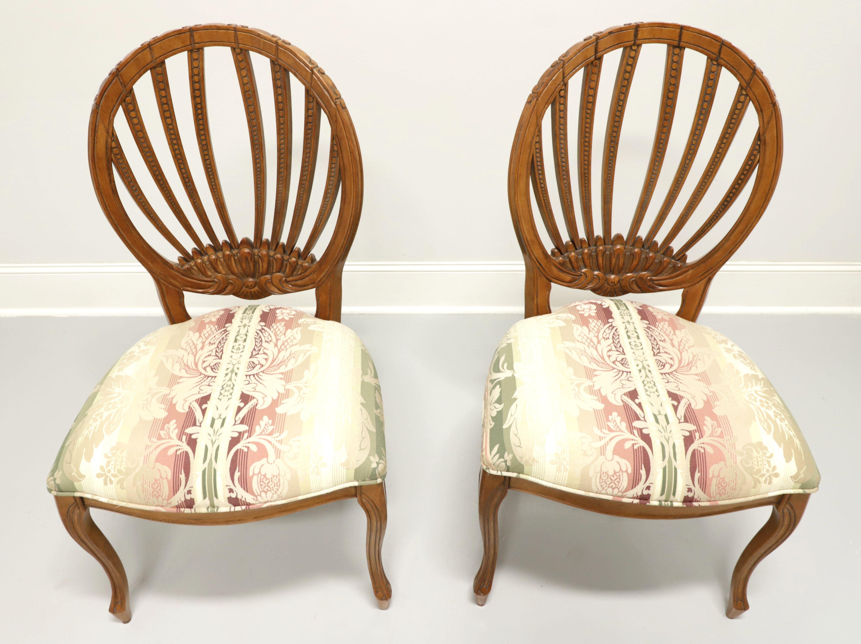 A pair of French Country style dining side chairs by Century Furniture, of Hickory, North Carolina, USA. Hardwood with a walnut finish, oval open carved design backs, floral striped pattern fabric upholstered seats and curved legs. Made in the early