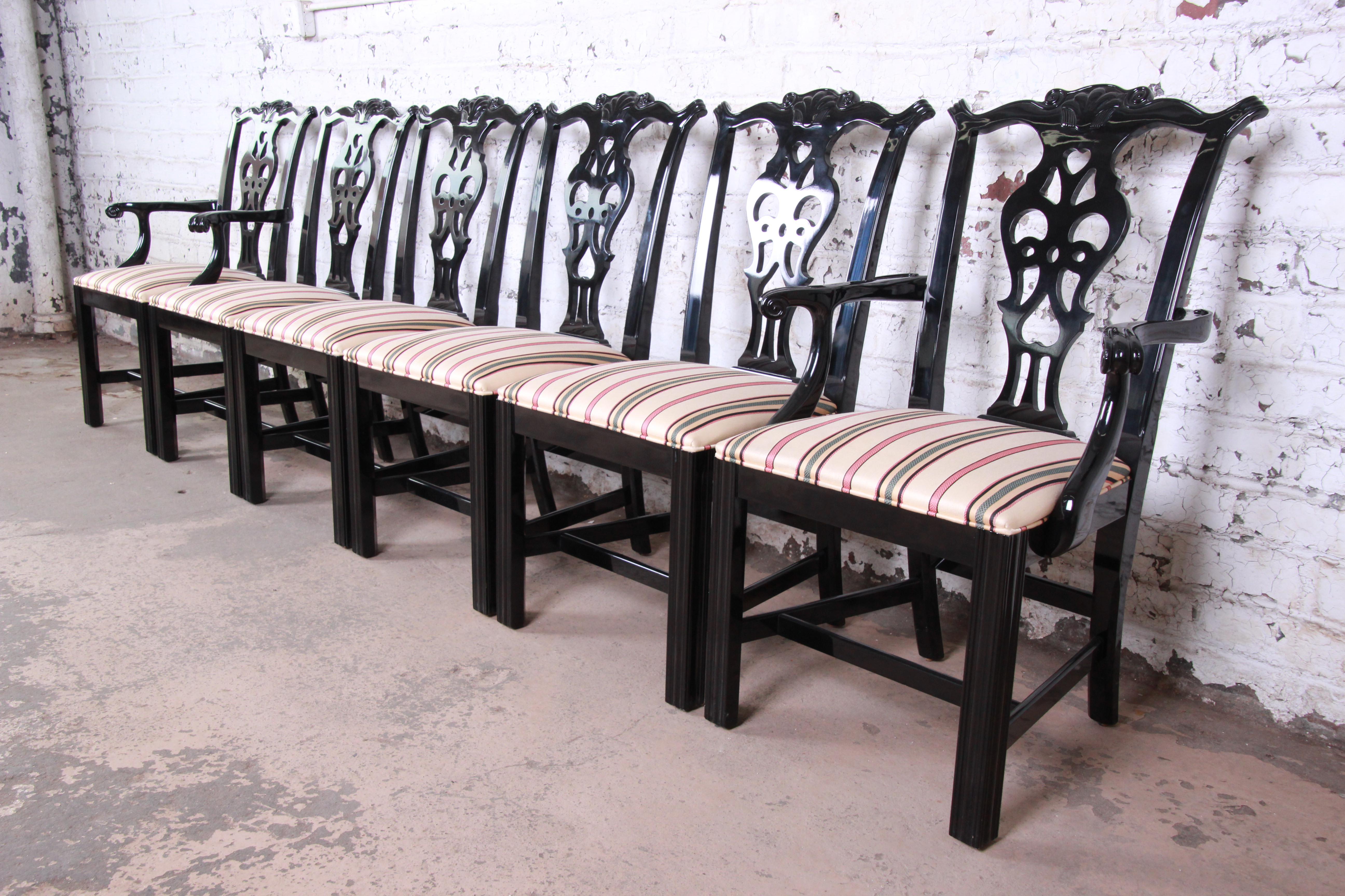 A beautiful set of black lacquered Chippendale style dining chairs by Century Furniture. The set includes two captain armchairs and four side chairs. The chairs feature solid wood construction with nice carved details and a high gloss black