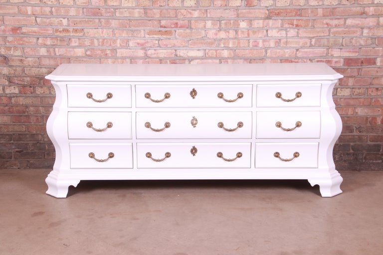A gorgeous Italian style bombay form triple dresser or credenza

By Century Furniture

USA, late 20th century

White lacquered mahogany, with original brass hardware.

Measures: 77