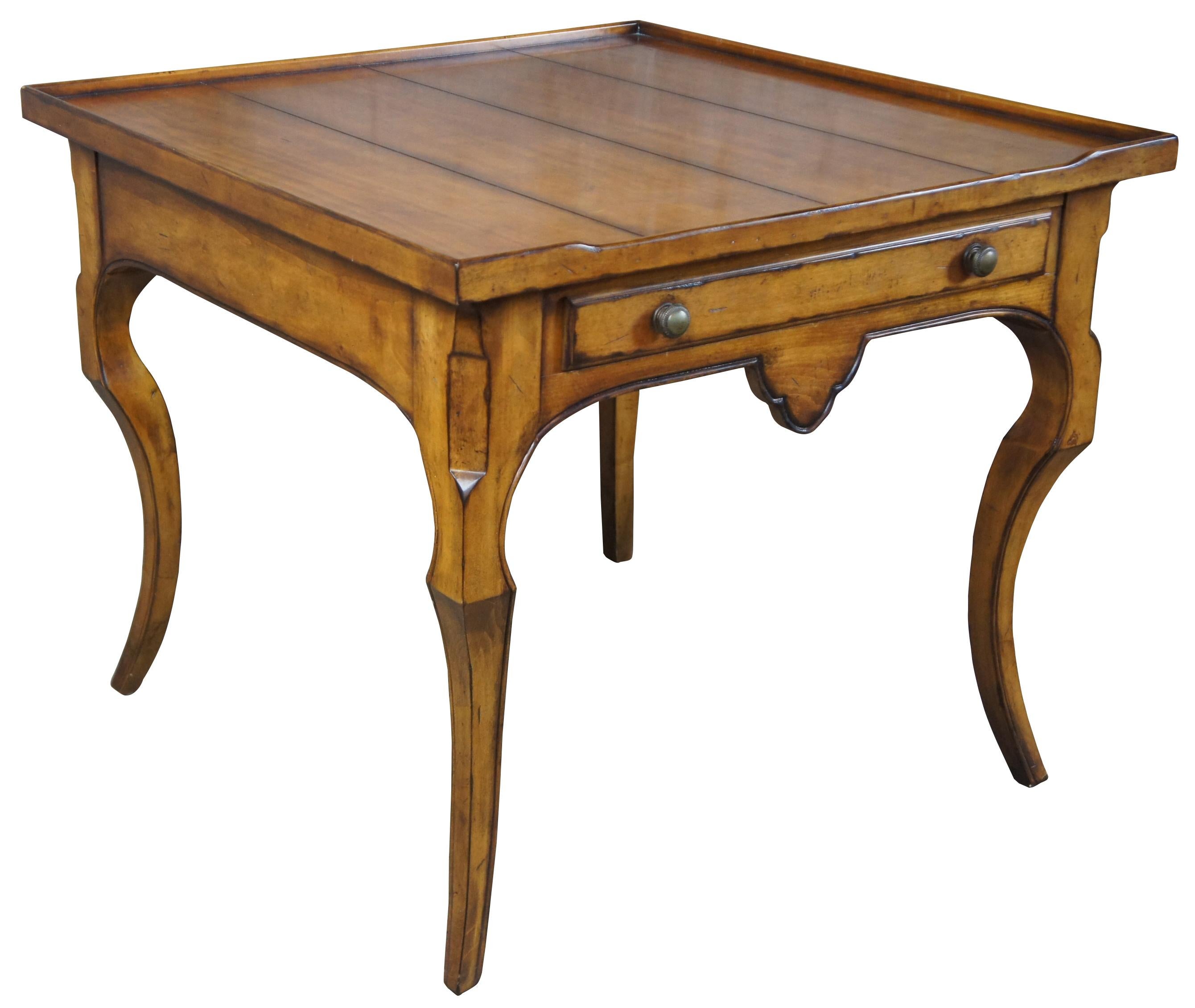 Century Furniture Brisbane chairside table. Made from maple with a distressed French country design. Includes flared legs and inset plank top with drawer.
 