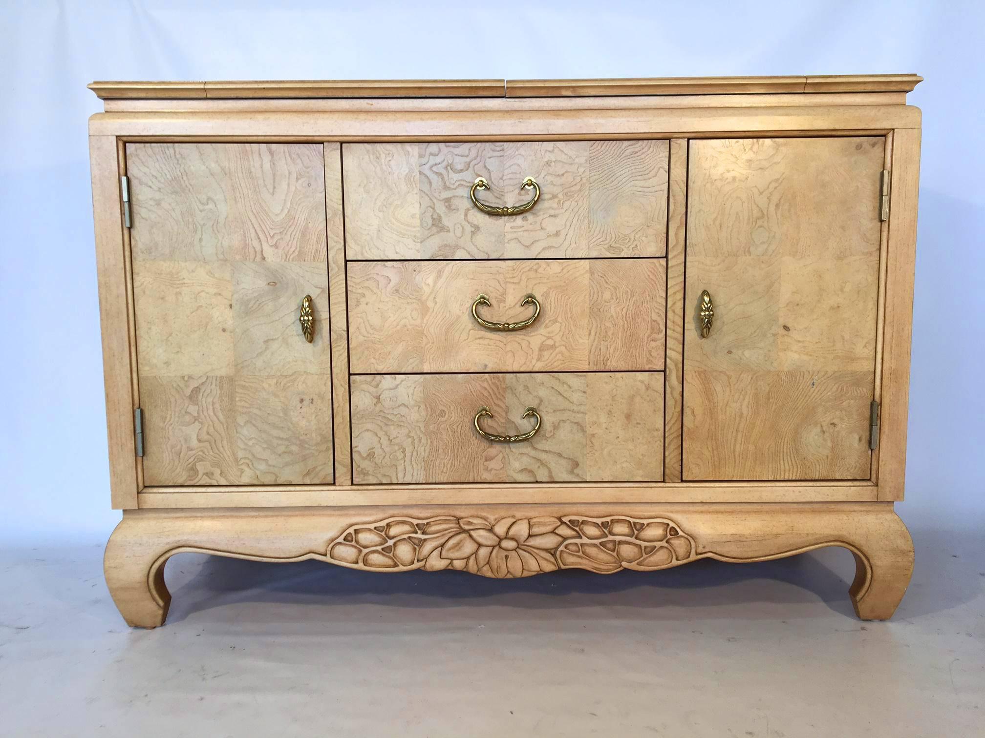 Asian style server buffet in light burl wood.
Created by Century Furniture Company.
Server sits atop Ming legs and features carved accents and brass hardware.
Three middle drawers flanked with side doors revealing storage and shelving.
Very good