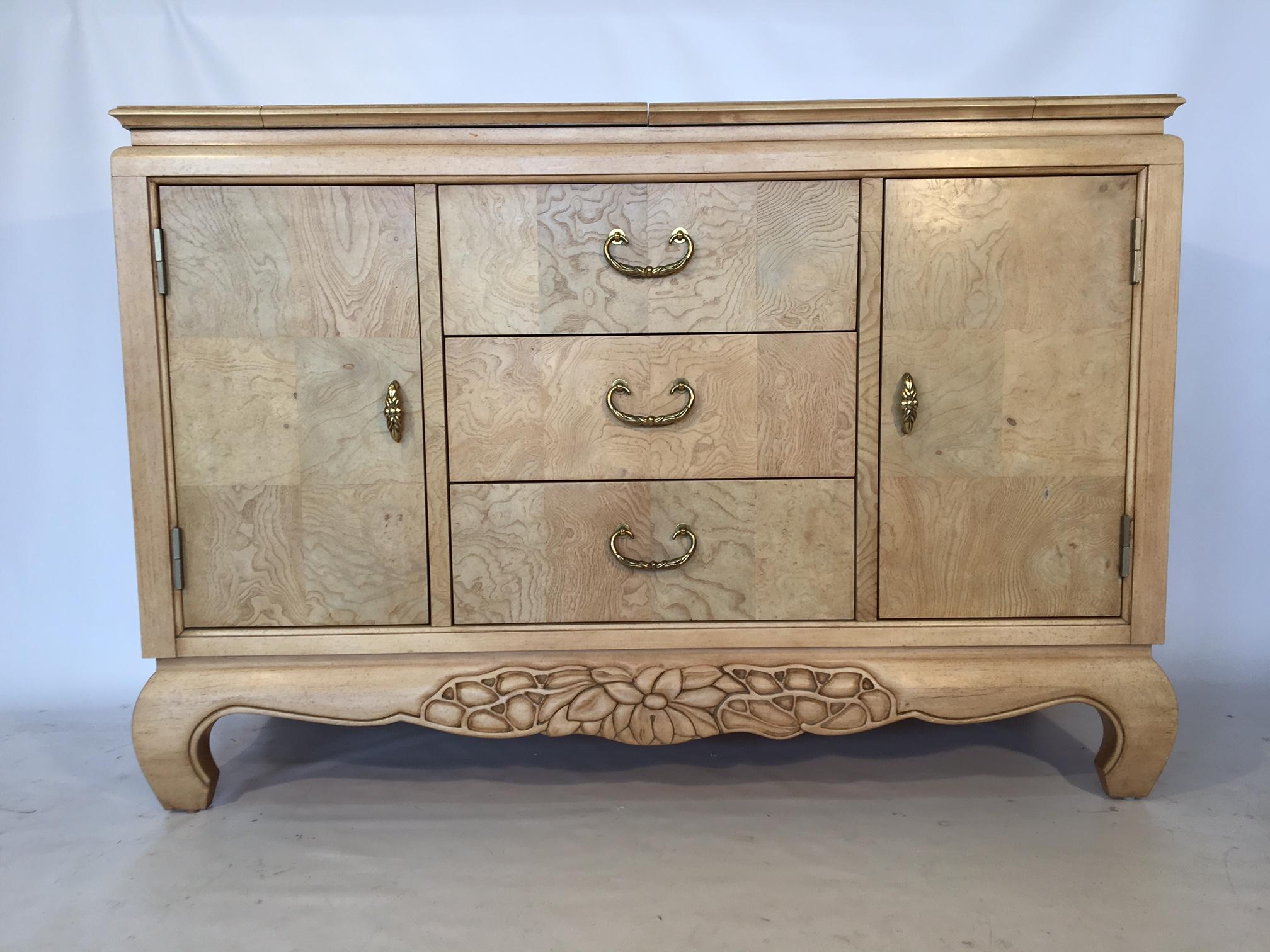Asian Style server buffet in light burl wood by Century Furniture Company.
Server sits atop Ming legs and features carved accents and brass hardware.
Three middle drawers flanked with side doors revealing storage and shelving.
Very good vintage