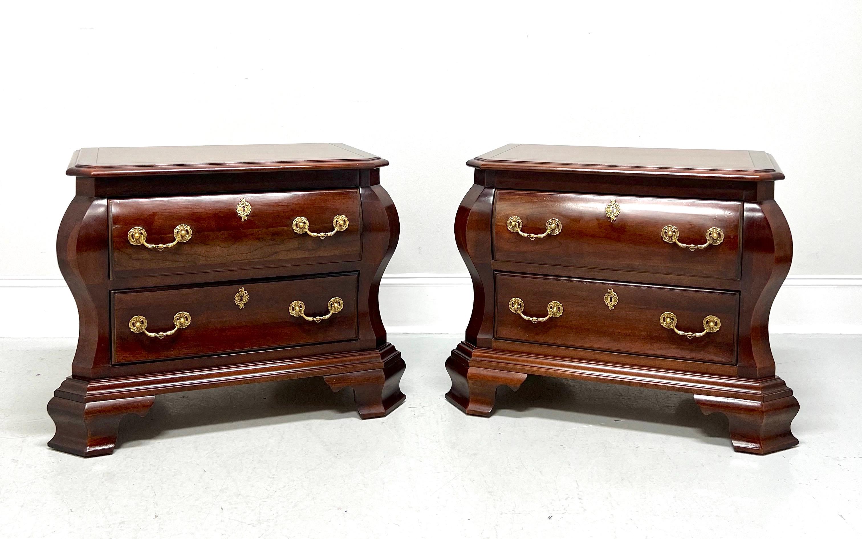 A pair of Italian Provincial style nightstands by Century Furniture, from their Cardella Collection. Cherry wood with decorative brass hardware, bombe shaped, banded top with bevel edge & clipped corners, and ogee bracket feet. Features two drawers