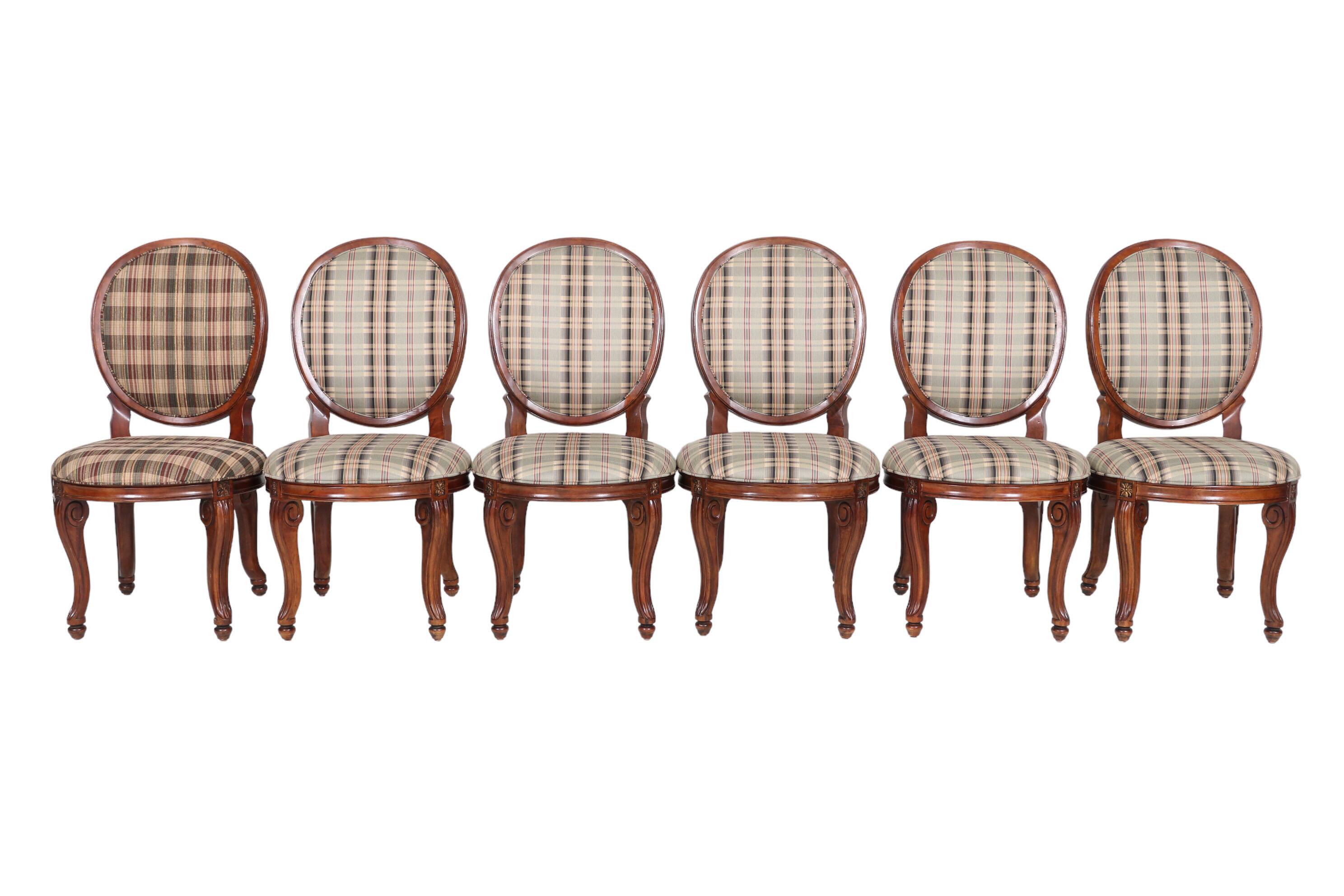 A set of six balloon back dining chairs made by Century Furniture of North Carolina. Round backs and seats are decorated with a simple beveled edge. Restrained cabriole legs are carved with a loose scroll at the top and finish in turnip feet.