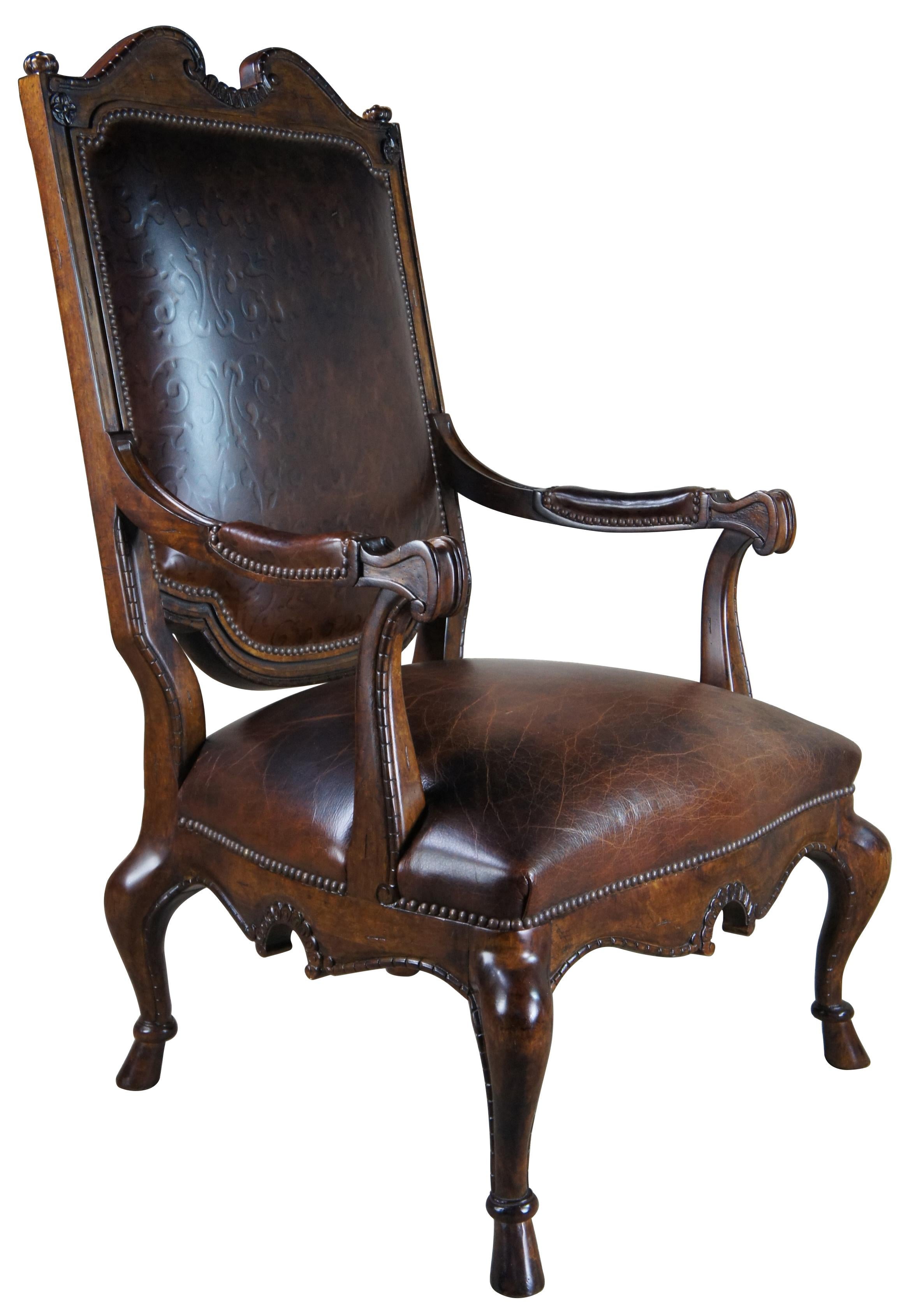 Century Furniture carved occasional armchair, circa 1990s Inspired by French Country styling with a high back and oversized form. Made from walnut with tooled brown leather, nailhead trim, cabrioe legs and hooved / hoof feat. The highback includes