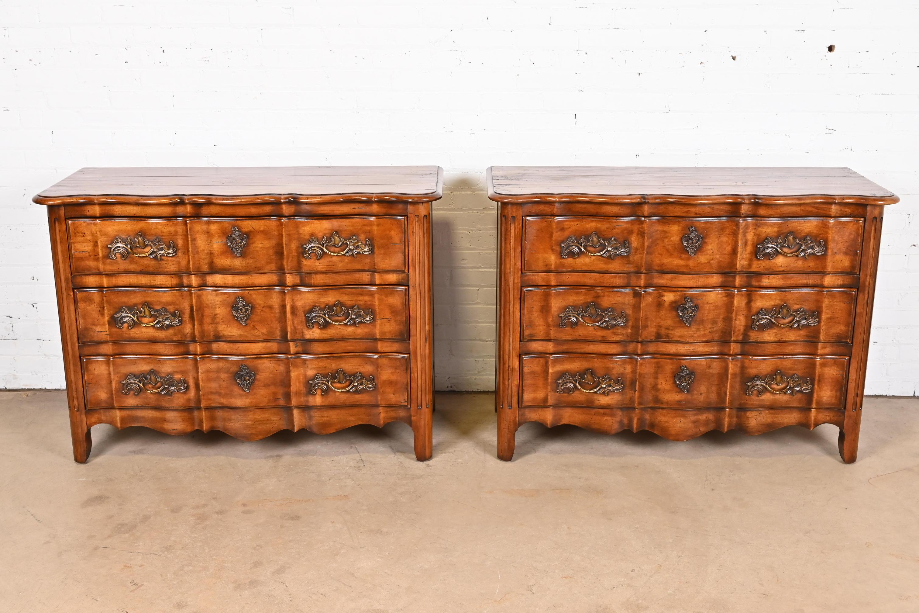 A gorgeous pair of French Provincial Louis XV style scalloped front dressers or chests of drawers

By Century Furniture

USA, Circa 1980s

Carved walnut, with original brass hardware.

Measures: 48