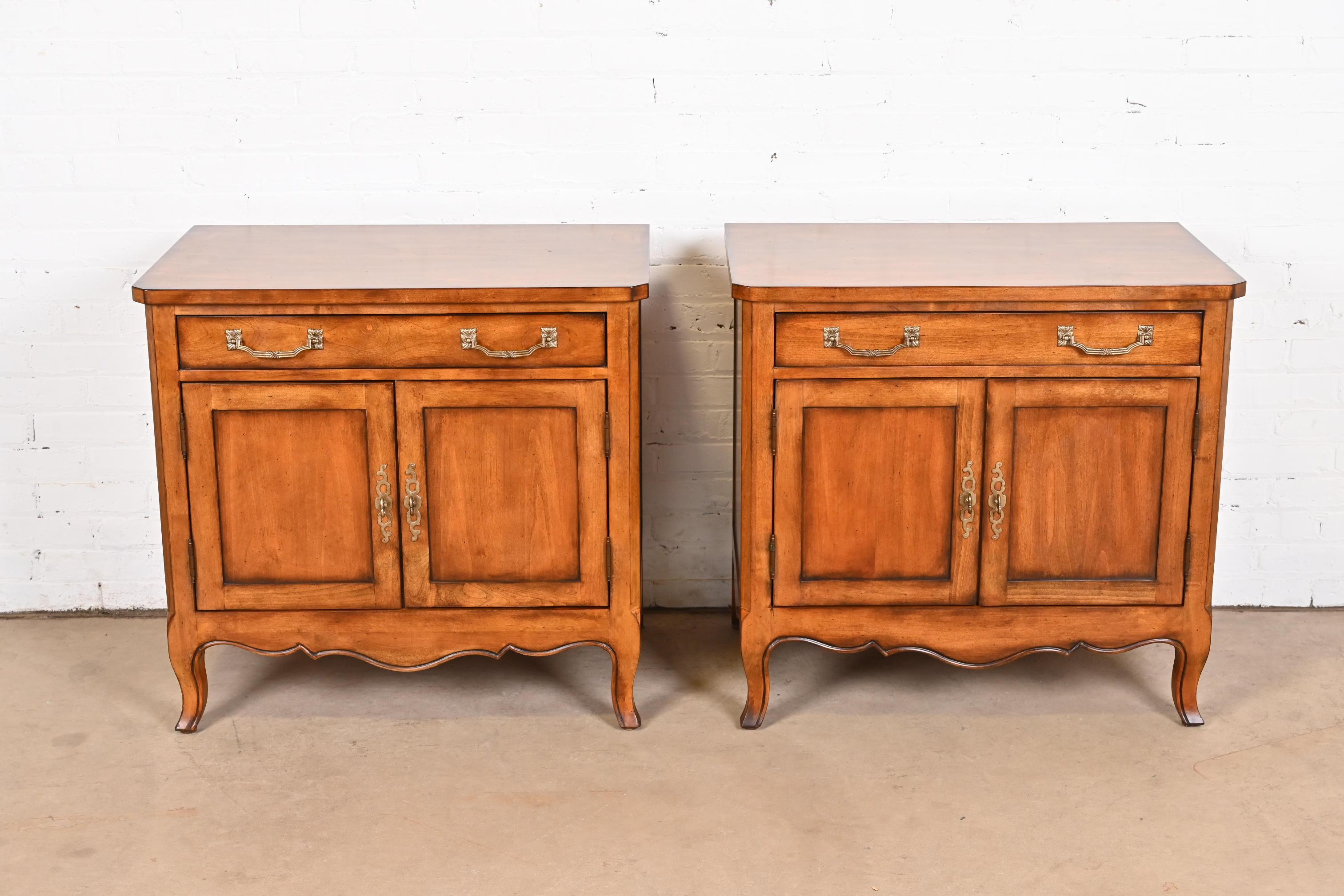 A beautiful pair of French Provincial Louis XV style nightstands or bedside chests

By Century Furniture

USA, Circa Late 20th Century

Carved cherry wood, with original brass hardware

Measures: 32