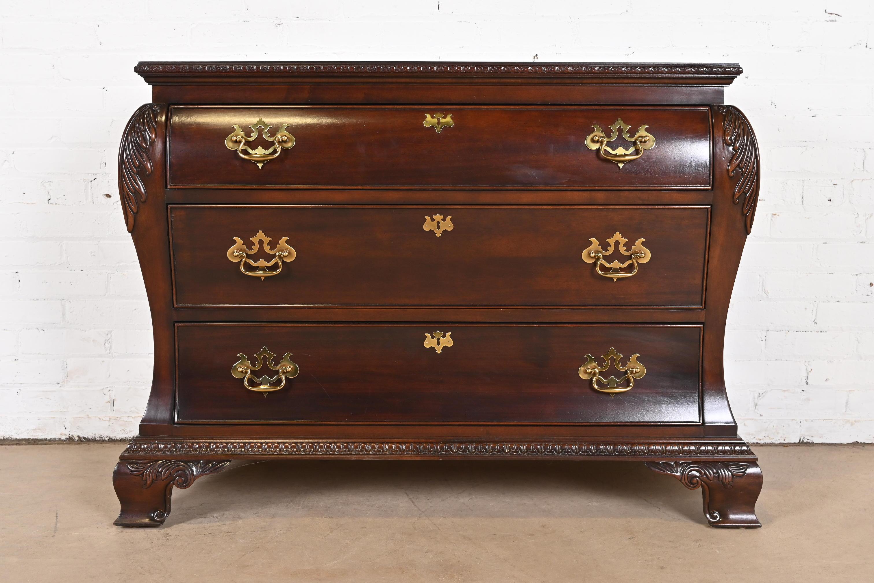 A beautiful Georgian or Chippendale style bombay form dresser, chest of drawers, or commode

By Century Furniture

USA, Late 20th Century

Carved mahogany, with original brass hardware.

Measures: 46.25