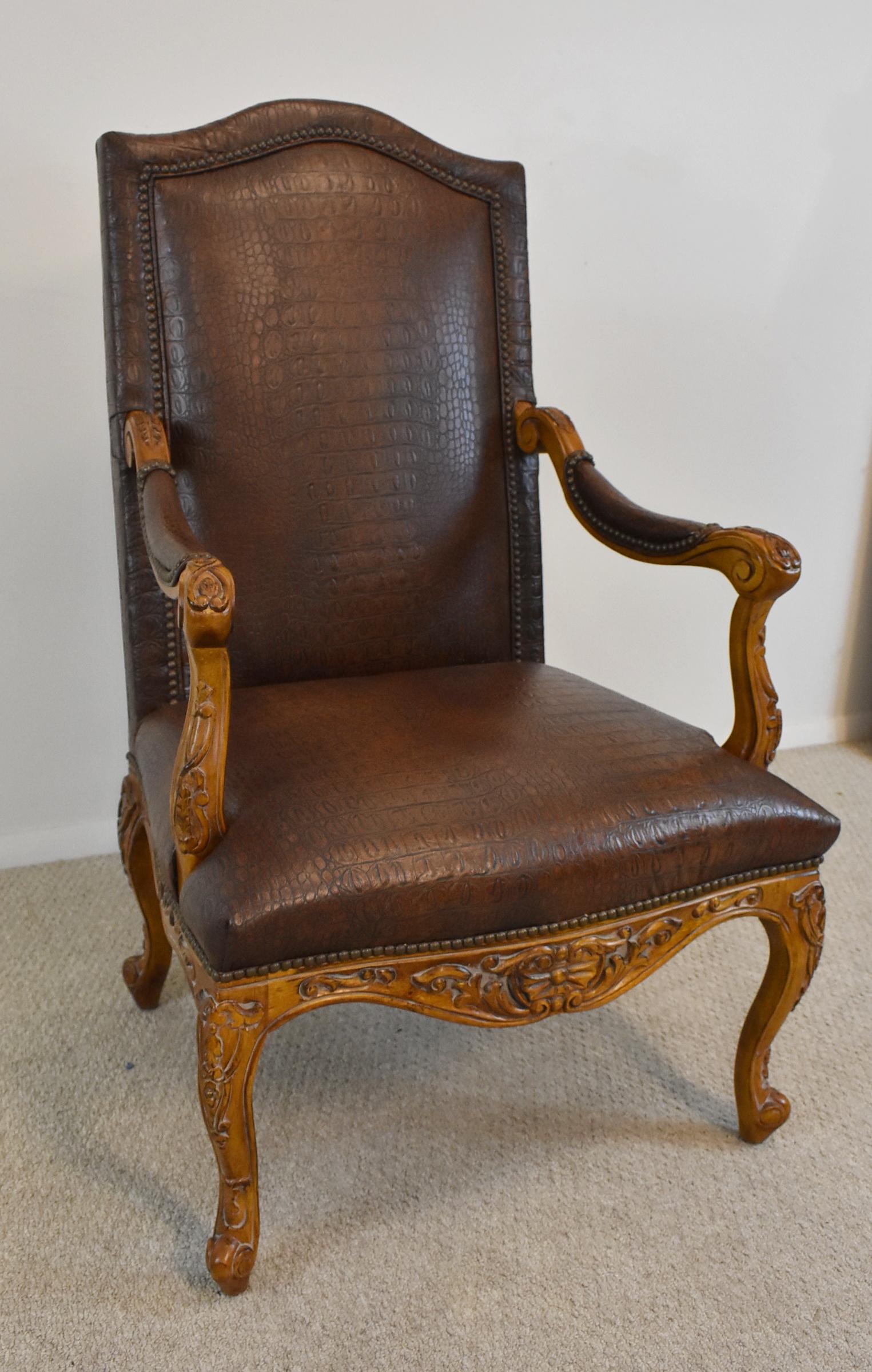 Century Furniture Highbacked Crocodile Embossed Leather Armchair. Circa 21st Century, pre-owned. Premium finish hand carved wooden frame. Brass nail head trim on embossed leather. Excellent condition, some wear is consistent with usage and age.