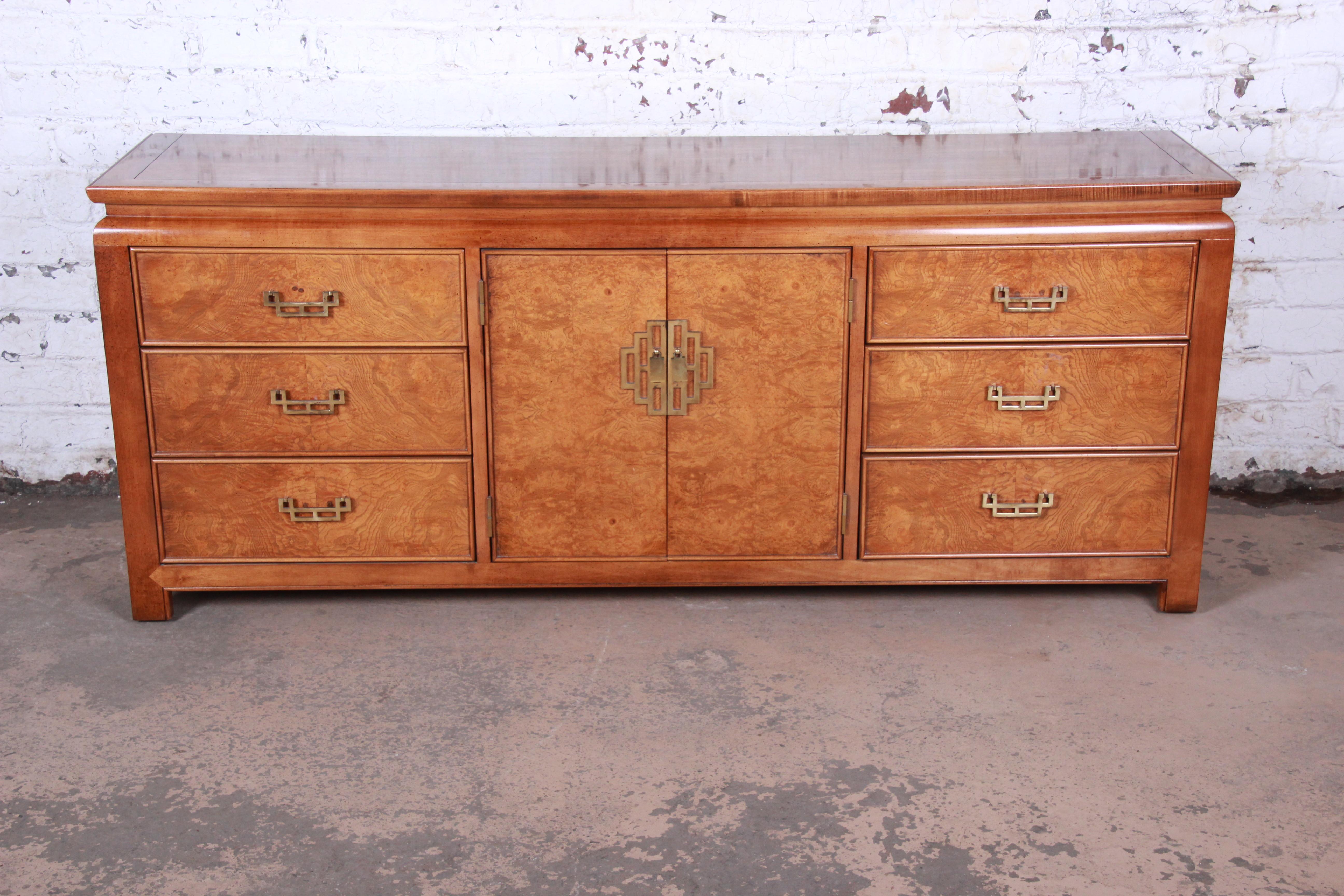 Midcentury Hollywood Regency chinoiserie triple dresser or credenza

Made by Century Furniture

USA, 1970s

Olive ash burl + mahogany + Asian inspired brass hardware

Measures: 76