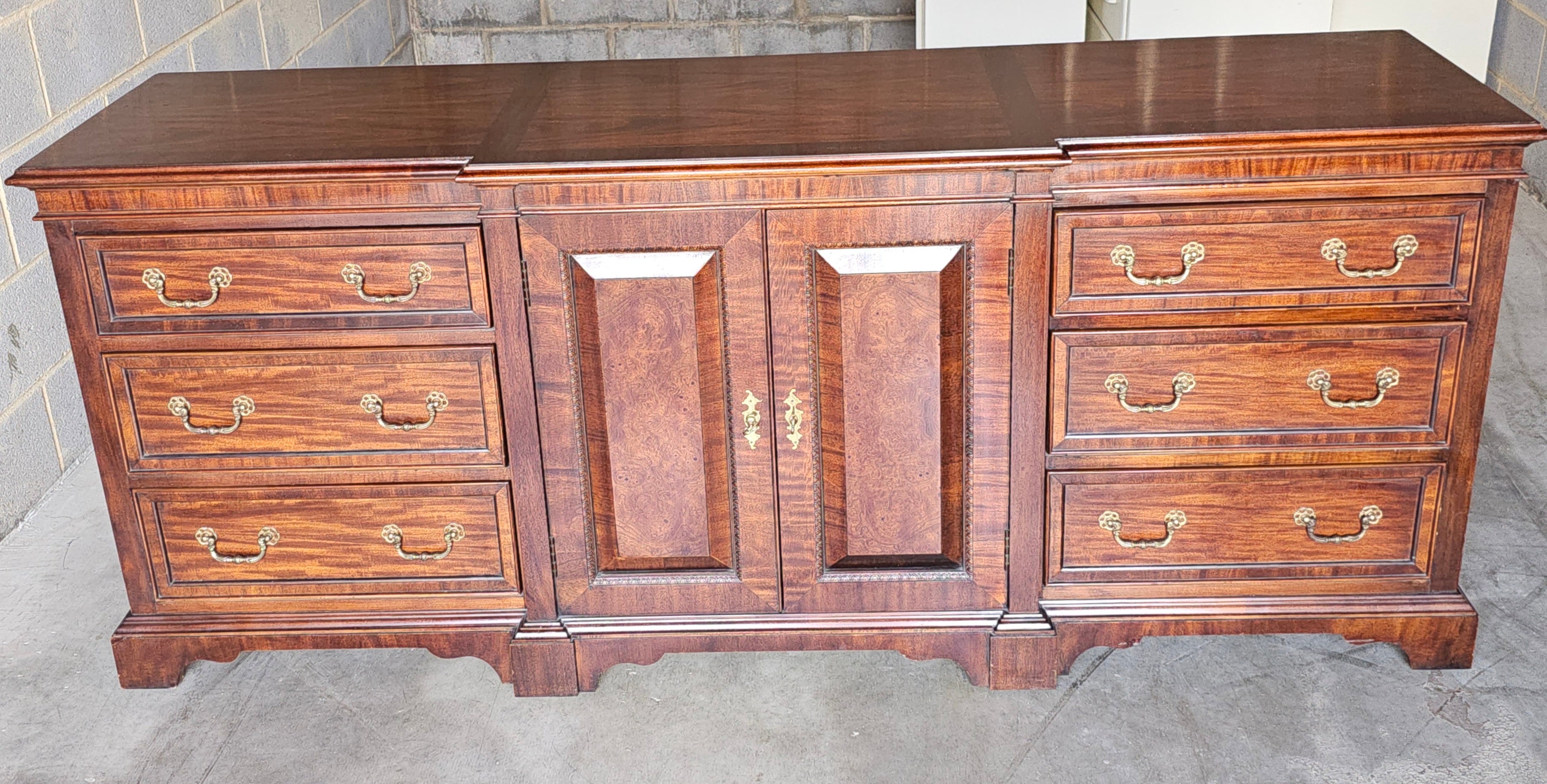 A Century Furniture of Distinction Satin Mahogany Triple Dresser in great vintage condition. Plenty of storage. Flawlessly opening and closing drawers. A matching pair of nightstands available in our inventory in a separate listing