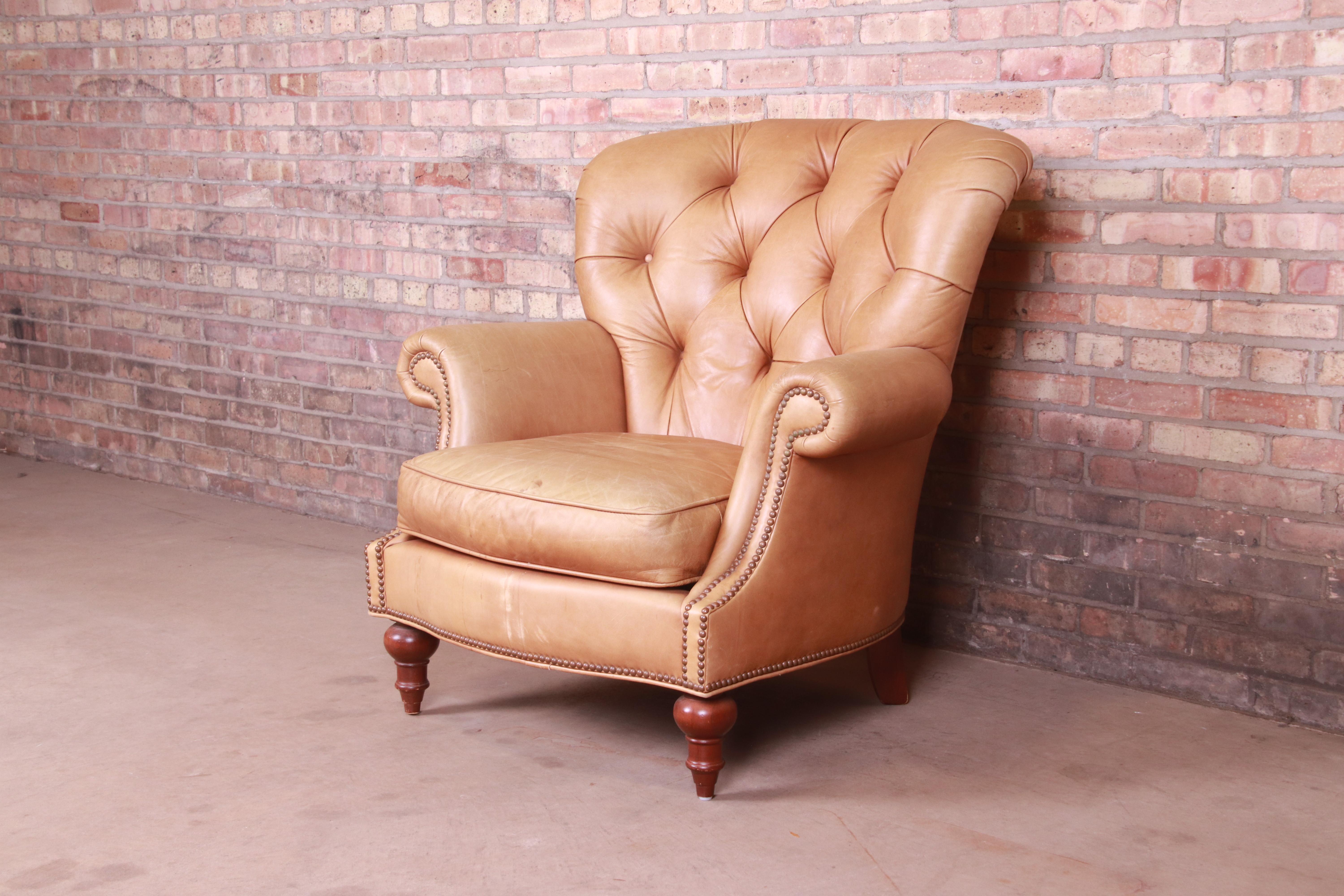 A gorgeous Chesterfield style club or lounge chair

By Century Furniture

USA, Circa 1980s

Tufted leather, with brass studs and turned mahogany legs.

Measures: 39