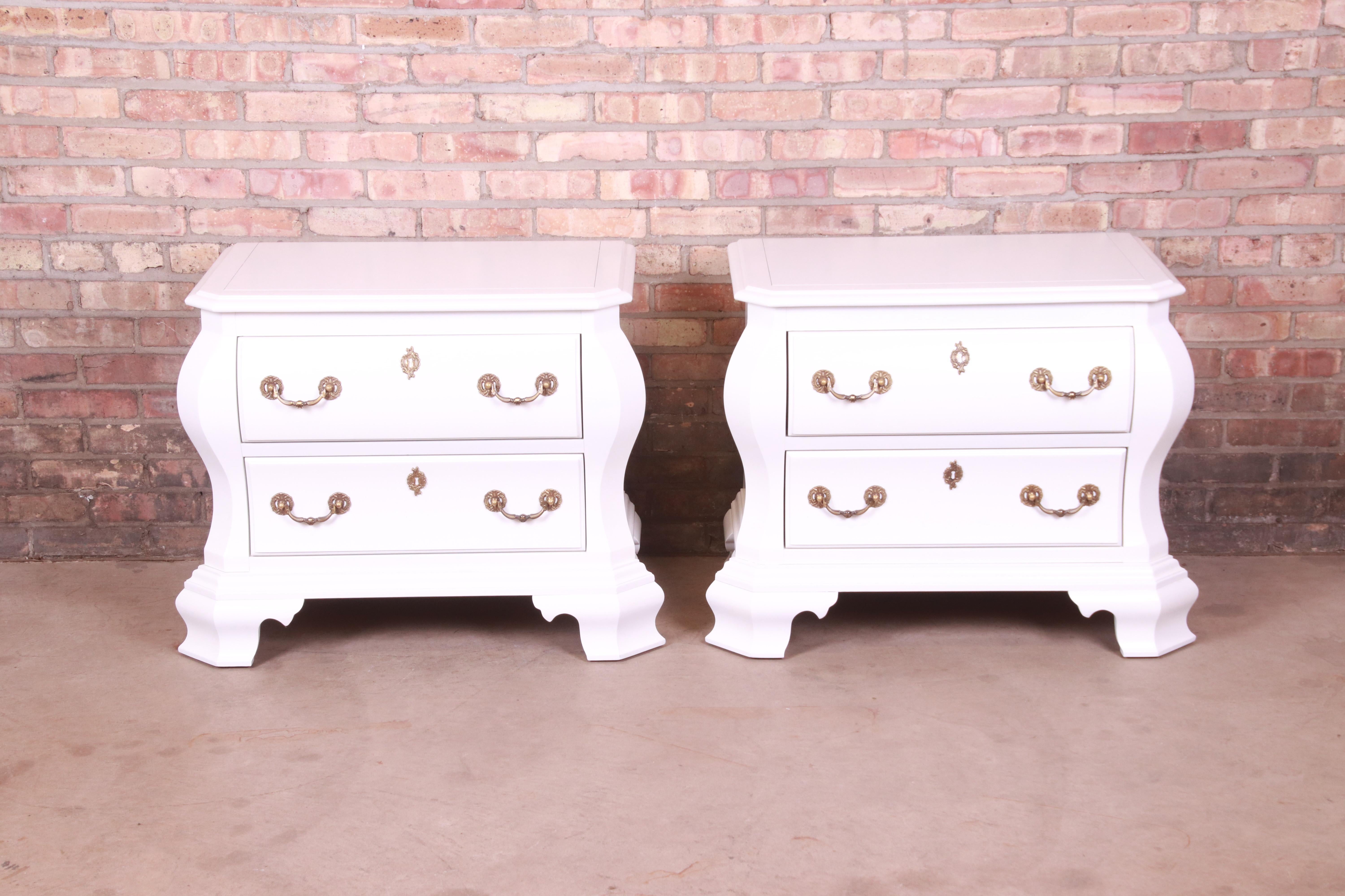 An exceptional pair of Italian Provincial style bombe chests or nightstands

By Century Furniture

USA, Late 20th Century

White lacquered mahogany, with original brass hardware.

Measures: 33.25