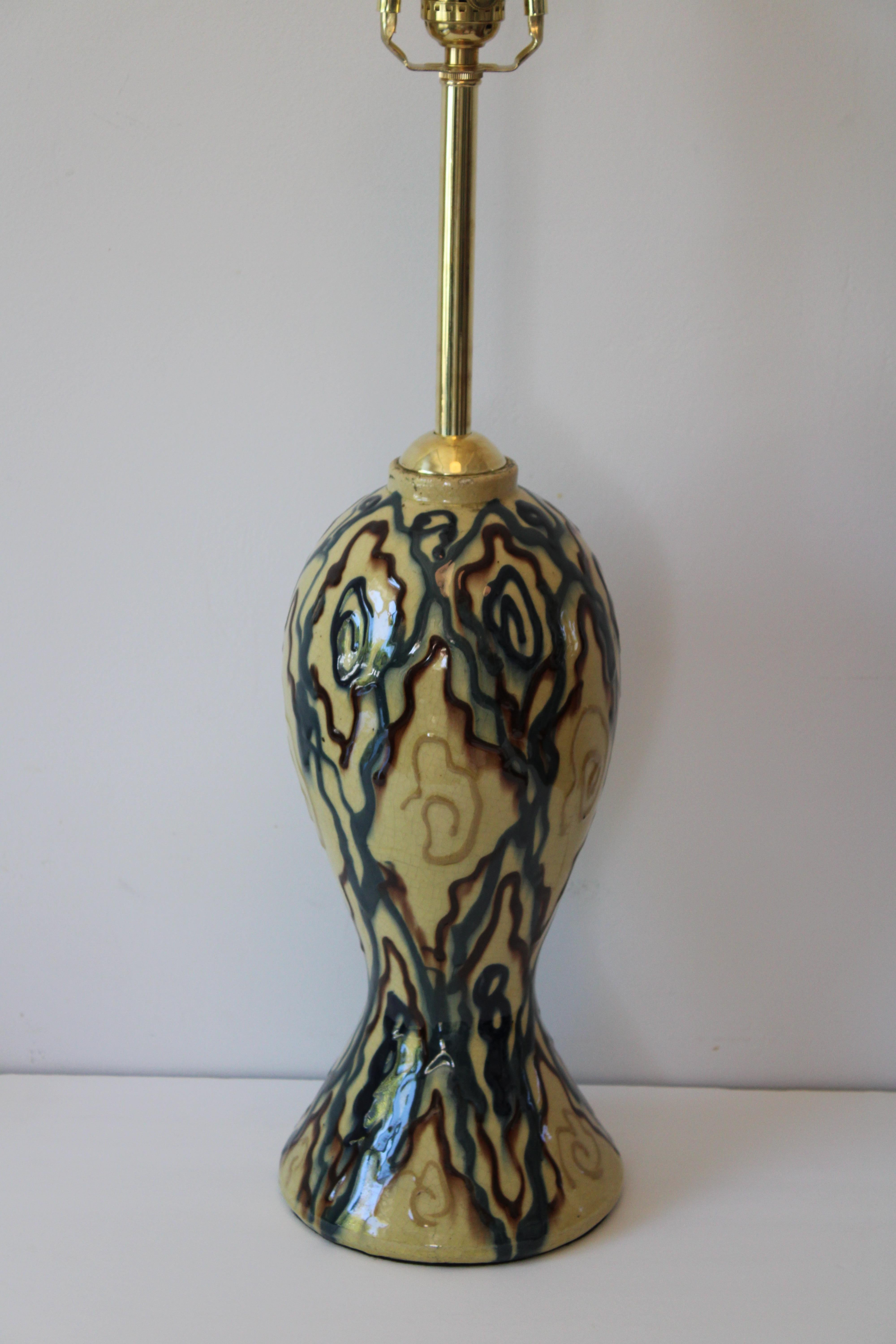 Ceramic abstract table lamp. We were told this lamp came from Belgium. Lamp has been professionally rewired with high quality brass hardware. We also polished the brass rod which is original.  Lamp measures 21