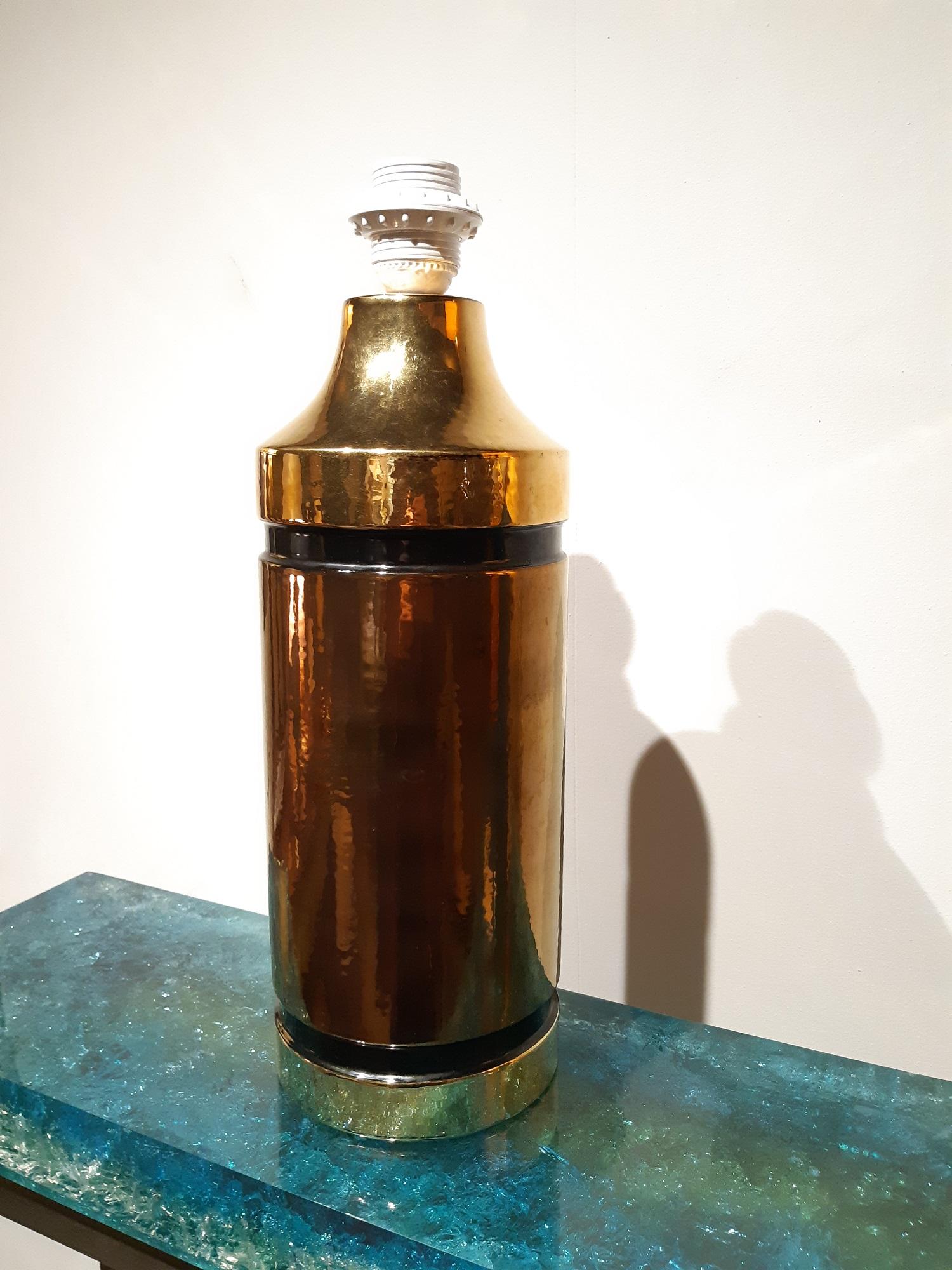 Aldo Londi lamp by the Italian manufacture Bitossi. Midcentury lamp made in the 1960s.

Ceramic gold and copper glaze.

Measure: Socket height 42cm.

Good conditions! Shade is not included.