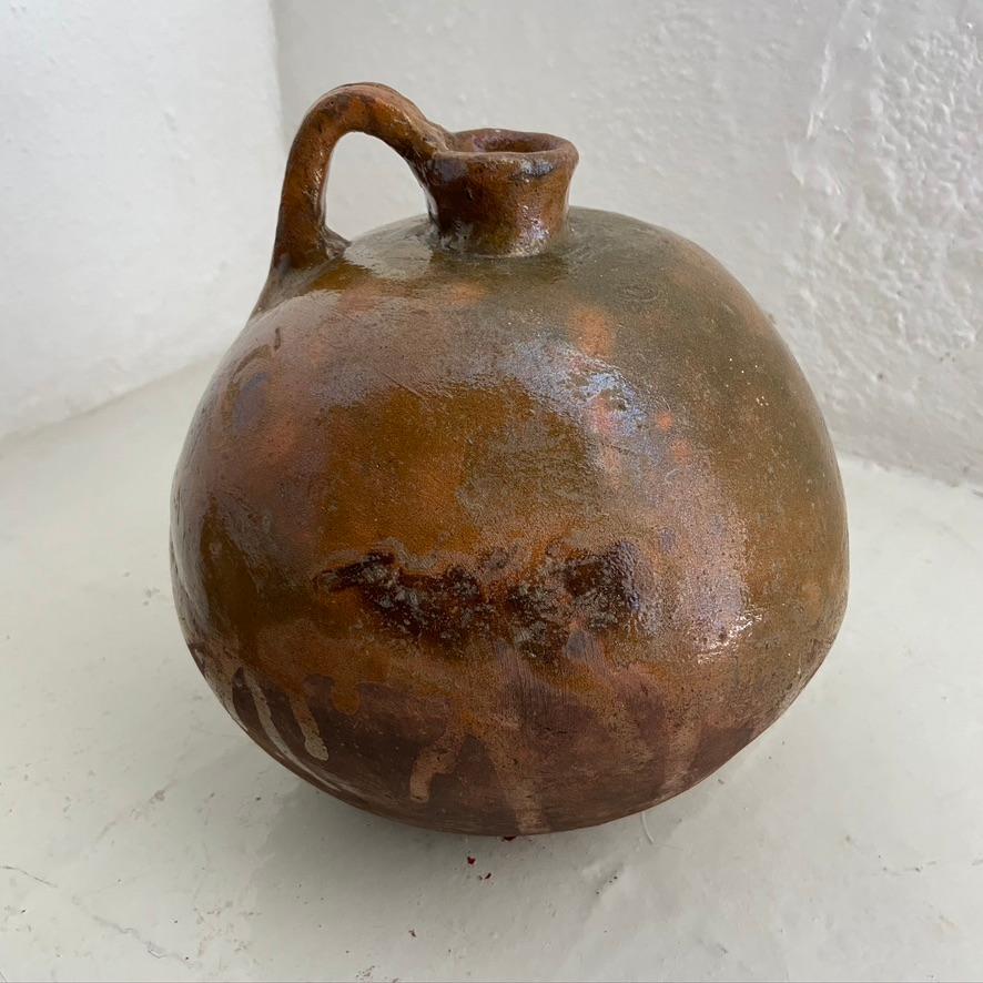 Ceramic amphora jug with glaze finish for holding 