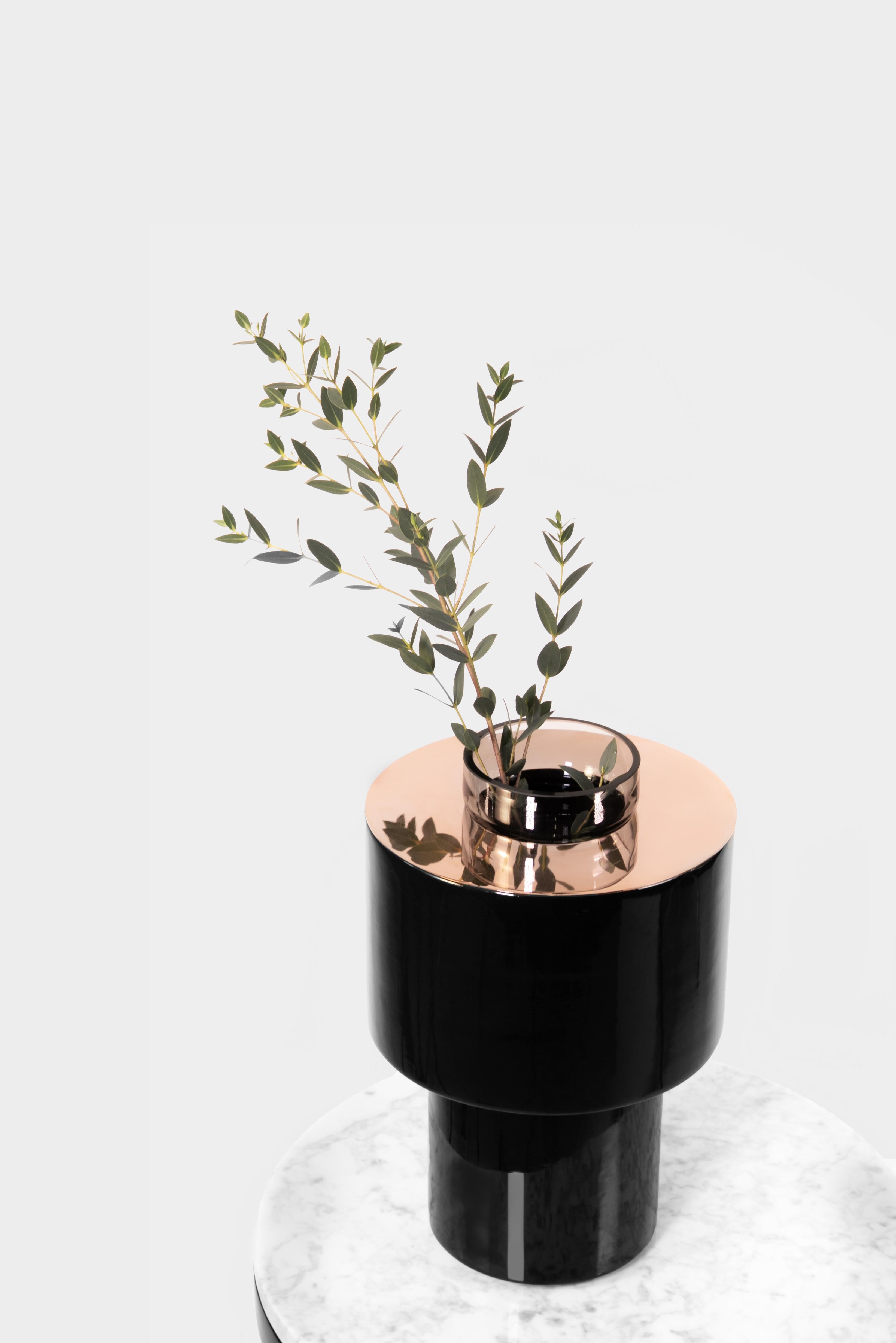 Ceramic and marble vase by Eric Willemart
Materials: Polished copper-plated disc
Black handcrafted ceramic
Dimensions: D 24 x H 28 cm

The container is made of grey blown glass and slides into the ceramic body. You can easily remove it to fill