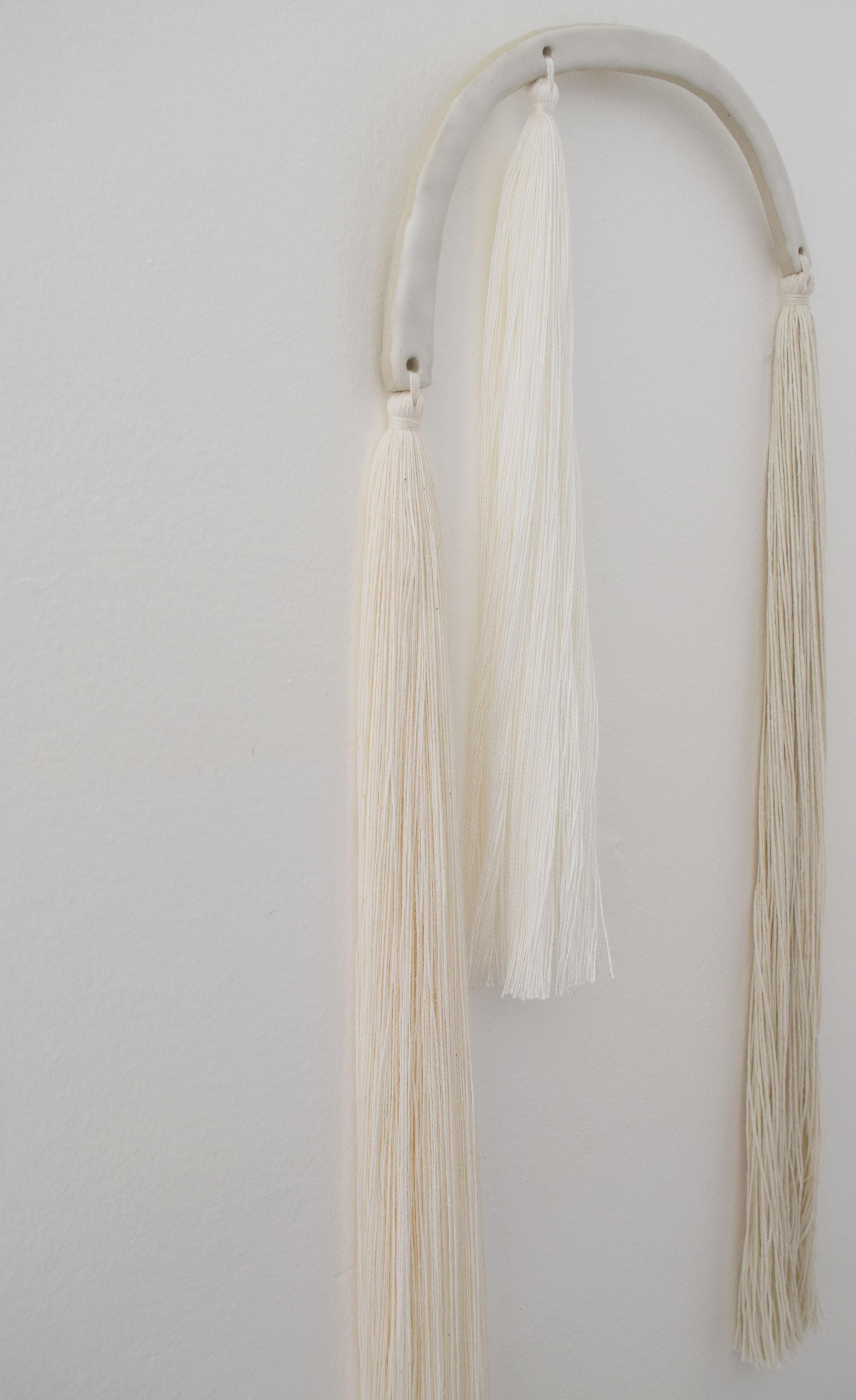 Wall sculpture #679 by Karen Gayle Tinney

Mixed material wall sculpture comprised of a ceramic panel with applied cotton and tencel fringe. The ceramic piece is hand formed out of stoneware and is glazed white. Fringe has been hand applied and