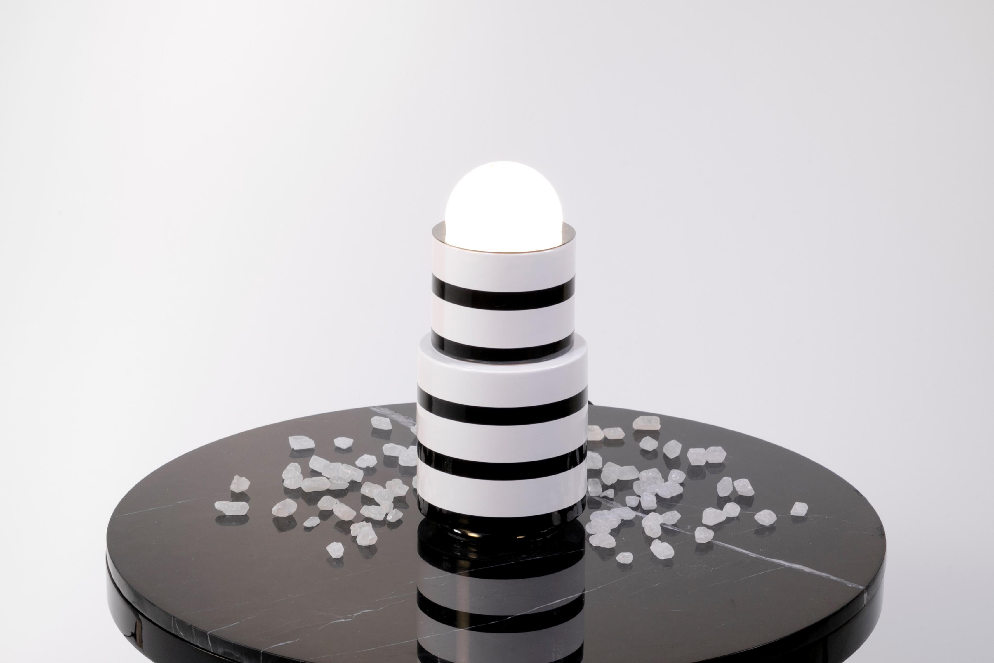 Ceramic and glass table lamp by Eric Willemart
Materials: Globe in mat white glass, black and white handcrafted ceramic
Base and top in polished silver plating
Light specifications: Socket E27, Bulb NUD White 80
Cable finish: Black