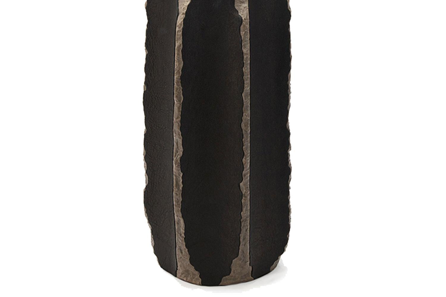 This handbuilt, nature inspired, textural lamp has ceramic base with black leather appliqué has a linen lamp shade and is made by French artist Gilles Caffier. 

Renowned for his unique and limited edition pieces, Gilles Caffier creates topical