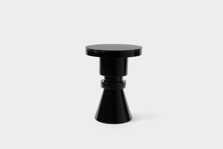 Ceramic and marble side table by Eric Willemart
Materials: Top: Polished Nero marquina marble plate embedded in a
black lacquered wooden tray
Body: Handcrafted ceramic glazed in black
Base: Black lacquered wood on an aluminium plate
Dimensions: