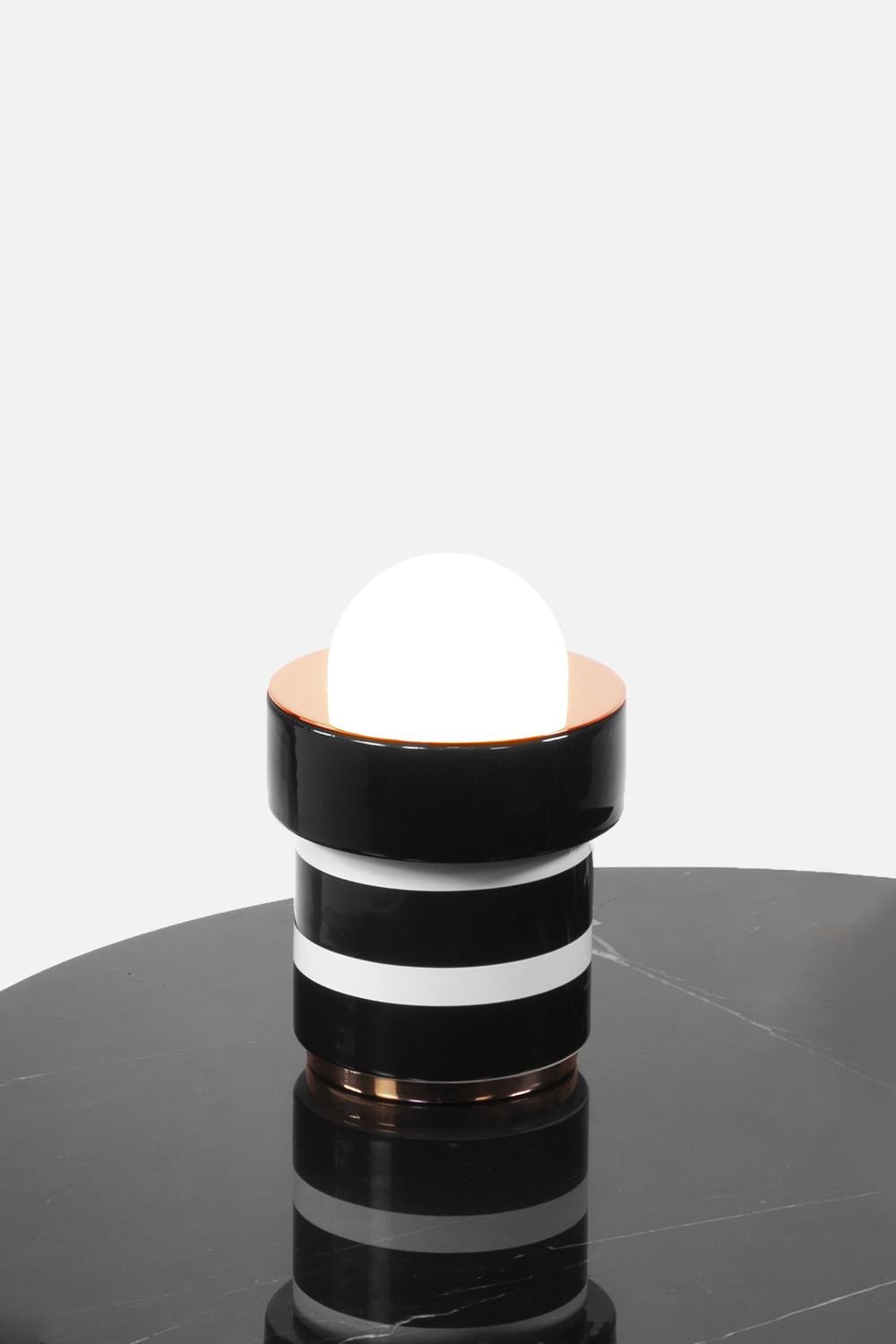 Ceramic and marble table lamp by Eric Willemart
Materials: Globe in mat white glass, black and white handcrafted ceramic
Base and top in polished copper plating
 Light specifications: Socket E27, Bulb NUD white 80
 Cable finish: Black