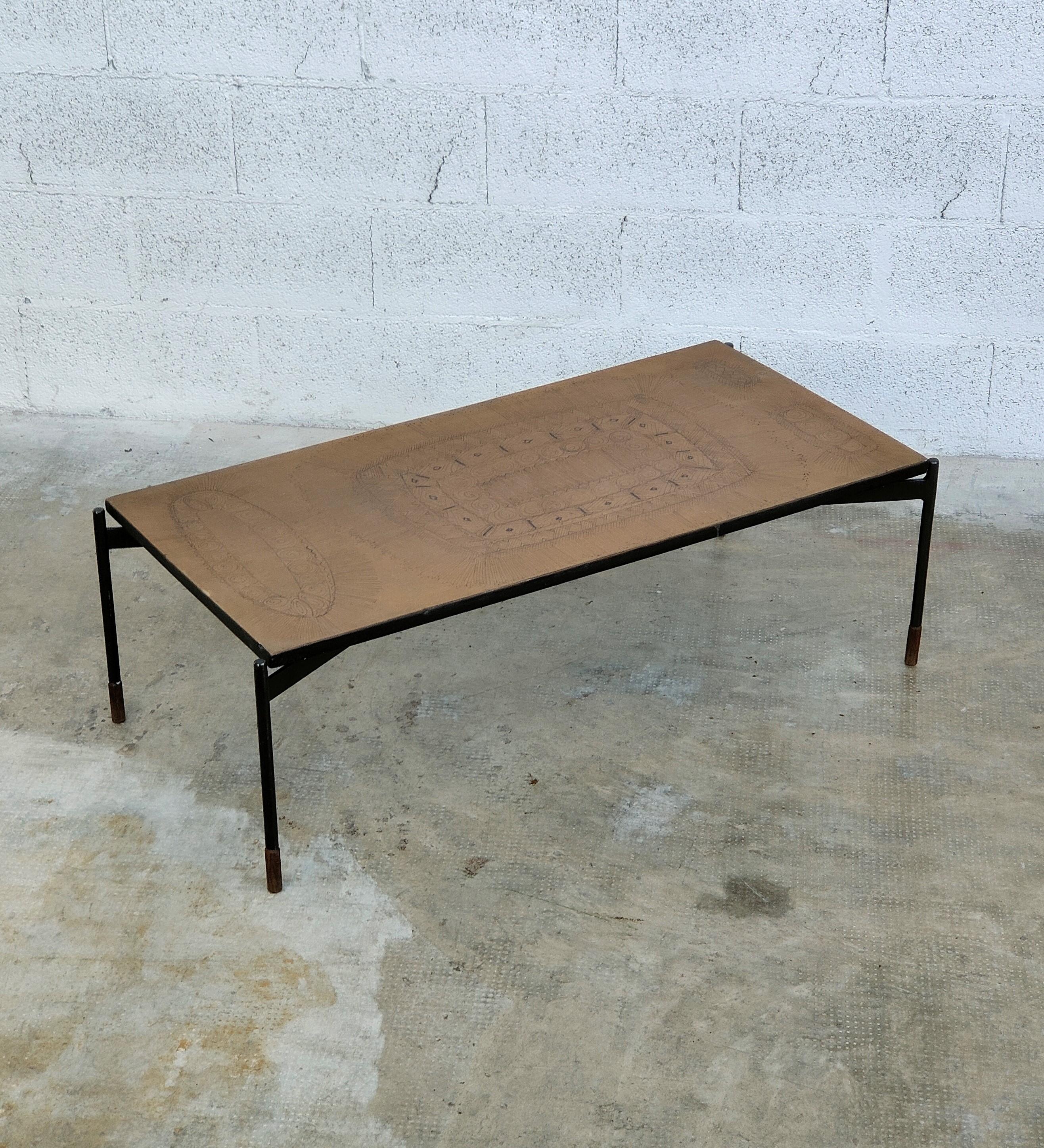 Stunning and unique coffee table made by Stil Keramos, Padova Italy in 1960s.
A decorated ceramic top laid on a black metal vernished frame.
Note the refinement of the wooden feet of the metal frame.

The 