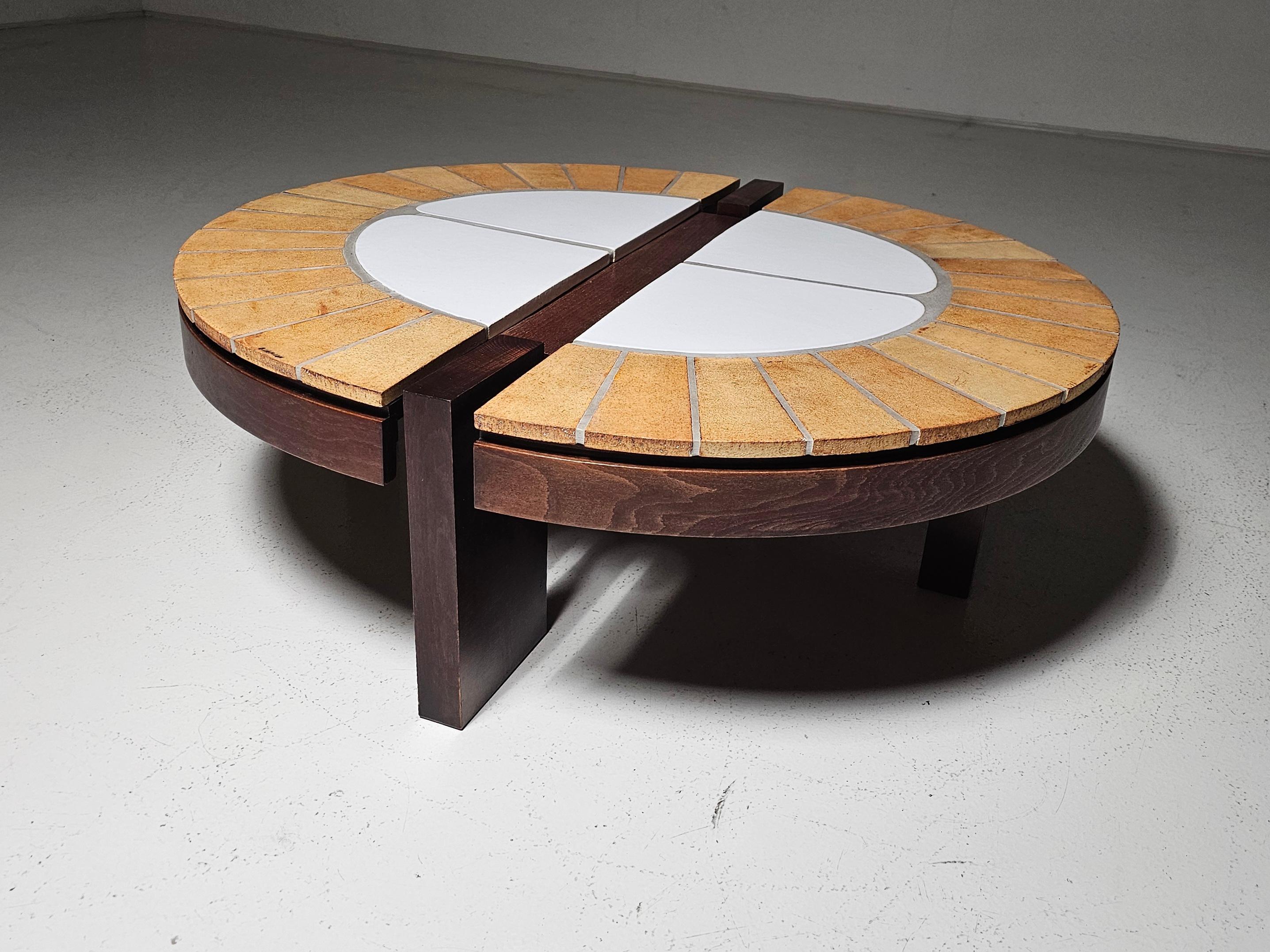 This exceptional coffee table is a creation of acclaimed French ceramist Roger Capron, a leading figure in mid-century decorative arts. Designed in the 1970s, the piece showcases his signature ceramic tile work, inspired by botanical motifs and the