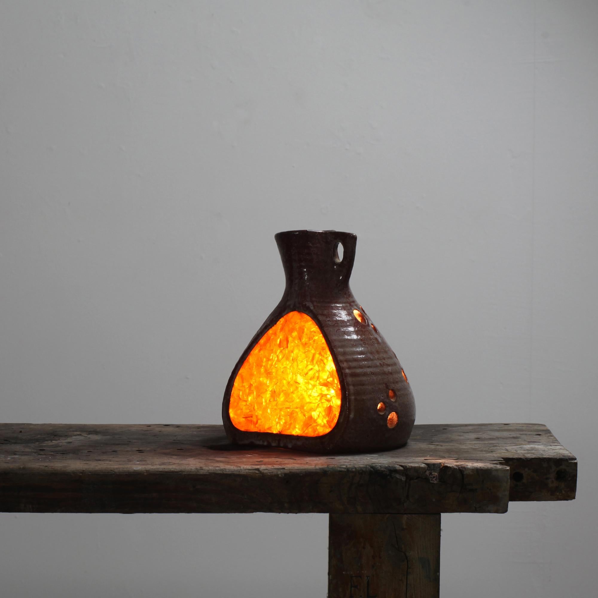 Lámpara de sobremesa fabricada por Les ateliers Accolay en Francia en la década de 1960.
Forma de jarra de cerámica con una gran incrustación de resina y orificios en la cerámica que permiten el paso de la luz.
Bonita escultura de Light.
Firmado en