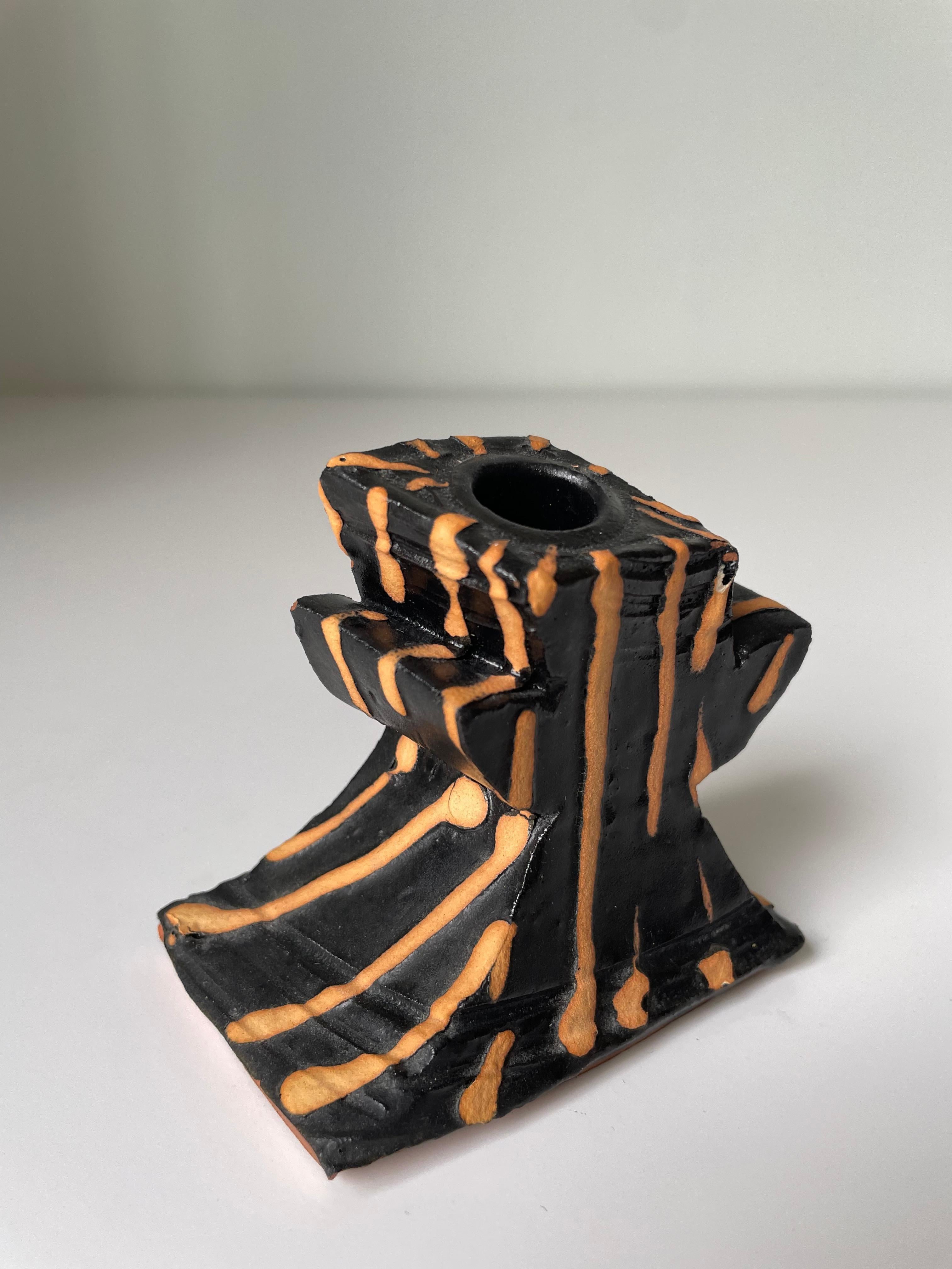 Sculptural organic modern black ceramic art candlestick or small vase with thick terracotta peach colored stripes. Winding body with two short “arms” and asymmetrical base. Handmade by the award-winning artist Richard Parker, one of New Zealand's