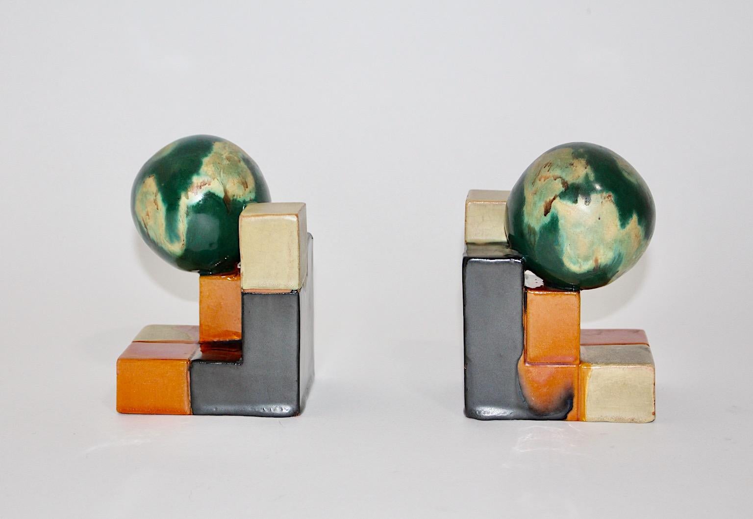 Ceramic Art Deco attributed vintage bookends or book stands, which were designed and manufactured 1920s Germany.
Beautiful multicolored fluted glaze surface in such pretty colors like green, black, orange and ivory and
geometric shape will make the