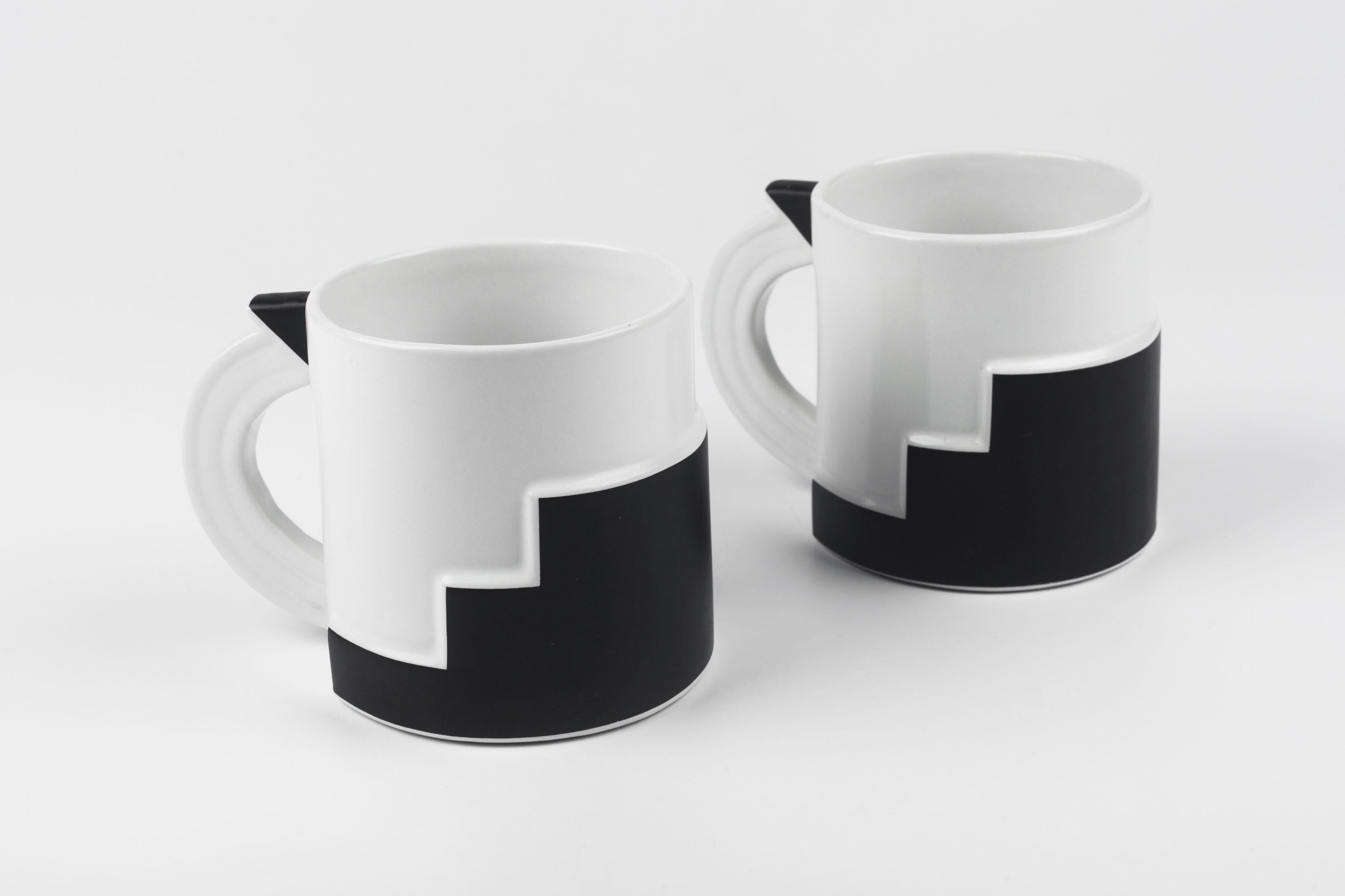 Black and white Art Deco inspired mug from 1980s Japan, designed by Kato Kogei for Fujimori. Black painted areas are matte, and there is a semi-gloss glaze on the white ceramic. Geometric black pattern on the mug has a subtle volume. Art Deco