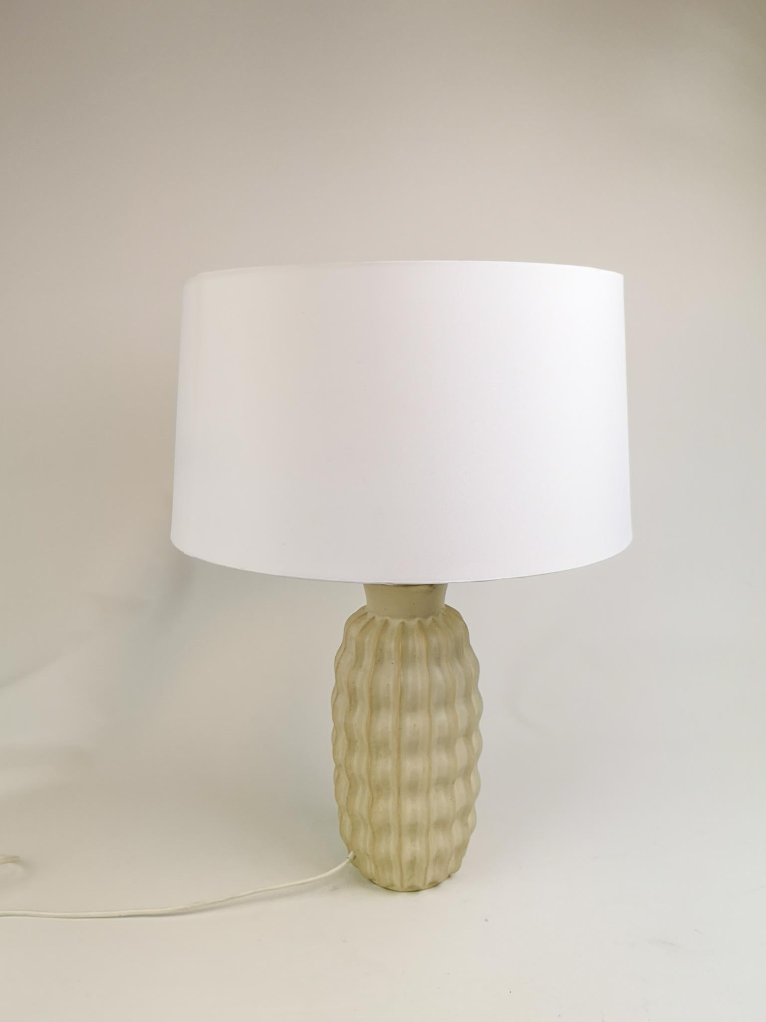 This wonderful ceramic Art Deco table lamp was made by Upsala Ekeby in Sweden 1930s-1940s.
It has an incredible form and figure and nice glaze. The shade is not original but can be included if byer wants.

Good working condition, scratches on the