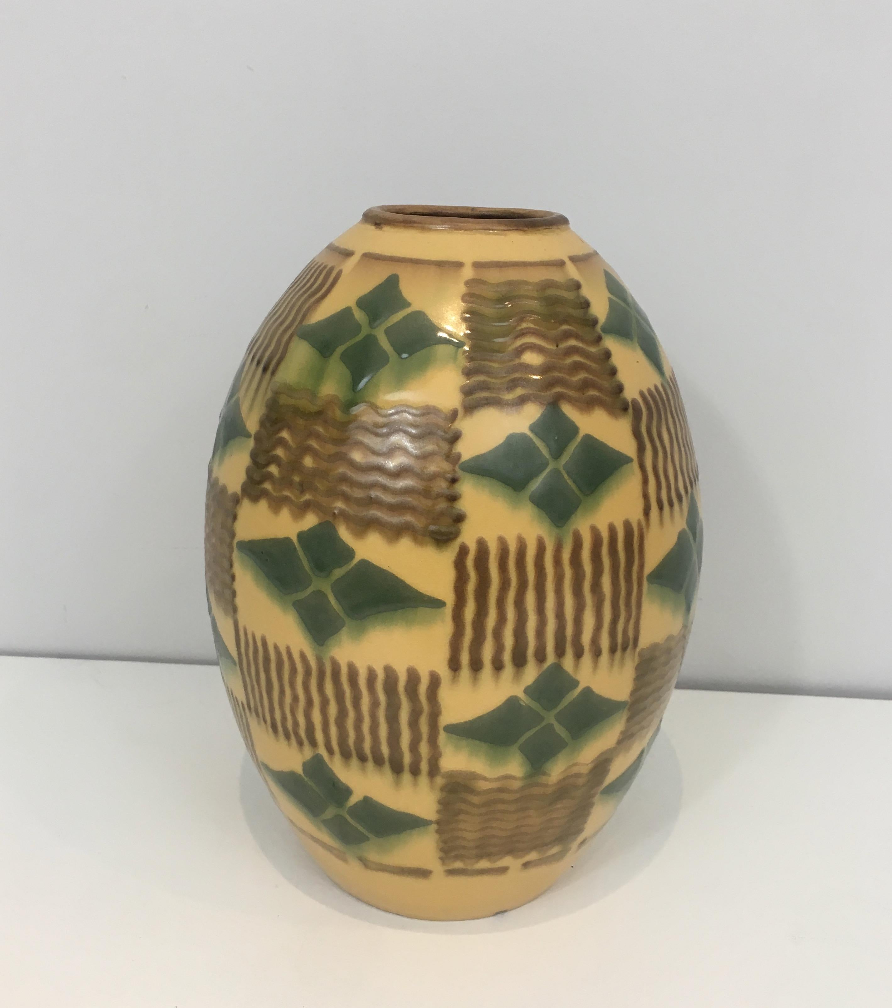 This Art Deco vase is made of ceramic. This is a beautiful piece with a nice design and great colors. This is a French piece of art, circa 1930.