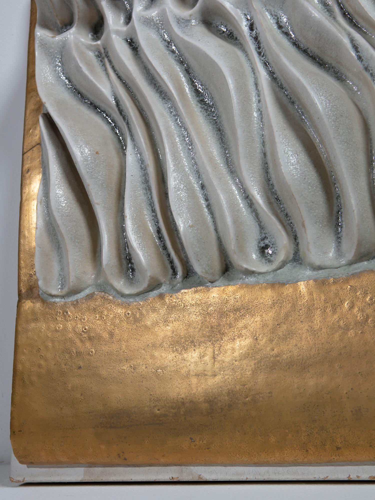 Wall mounted One-off ceramic sculpture by Carlo Zauli.
The central relief is surrounded by gold-leaf surface.
