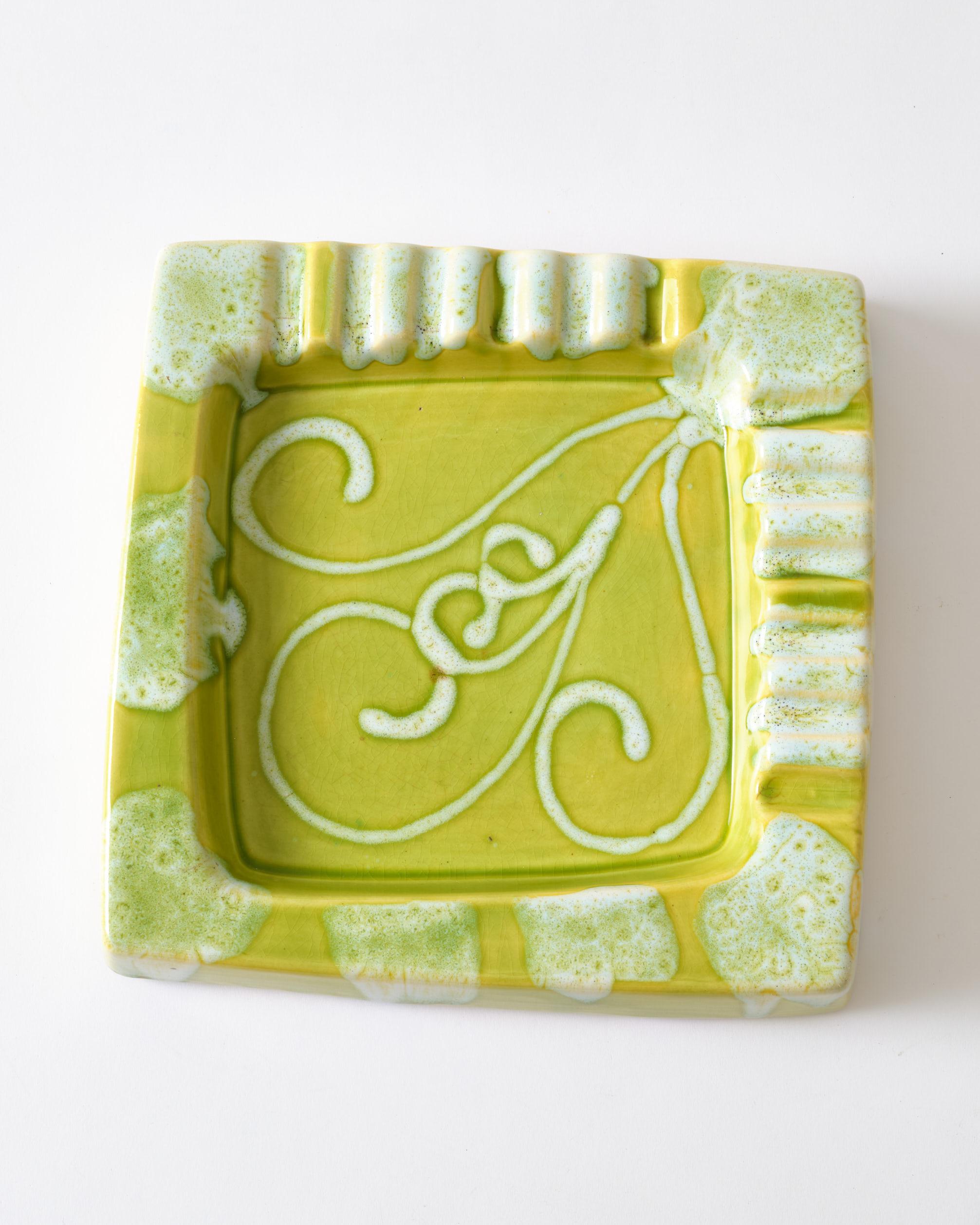 Large lime green ashtray which can be used as a decorative item.
The ashtray has a swirly white pattern inside the bowl and white pouring effect on the edges. The item is from the 1950's.