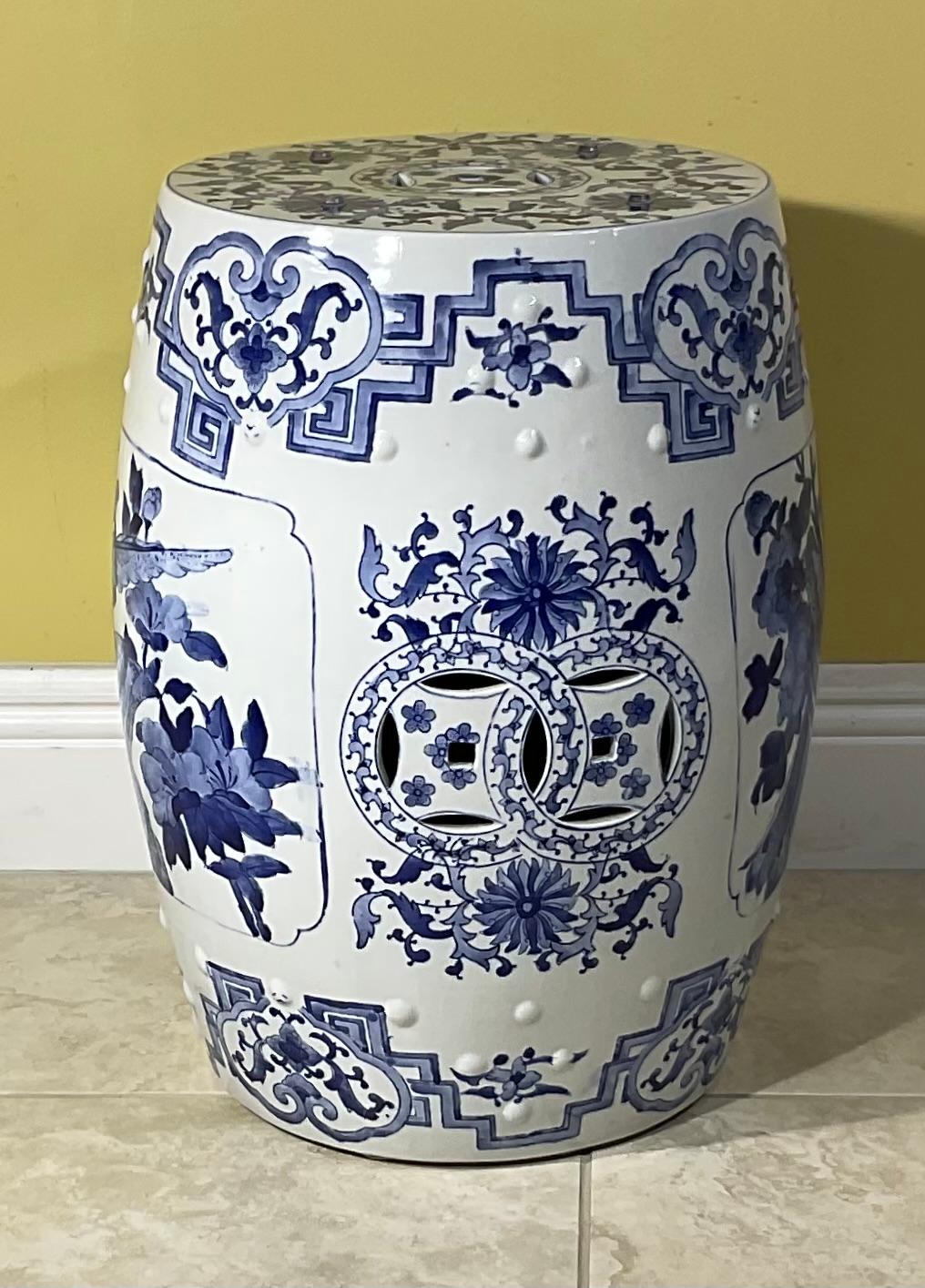 Asian ceramic garden seat or end table in blue and white floral motif. Blue and white Chinese style ceramic garden stool with hand-painted striking floral chinoiserie floral art work. Great to use indoor or outdoor as a stool or stand for plants.