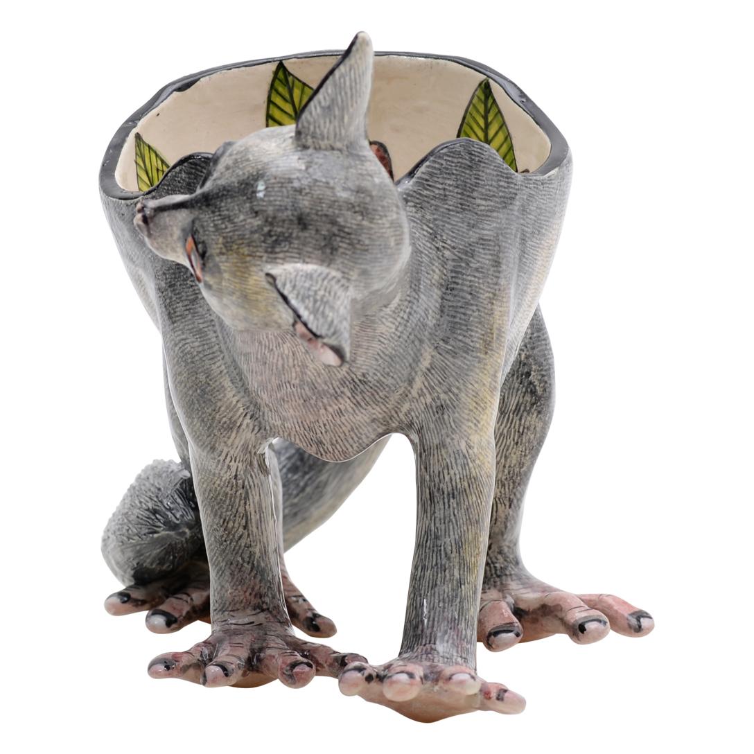 Introducing the vibrant ceramic Baby Bush peanut bowl, a unique creation from Imvelo Natural Art, South Africa. Hand-sculpted by Bernard and hand-painted by Elvis Mkhize, this striking piece measures 7 inches high, 13 inches in length, and 5 inches